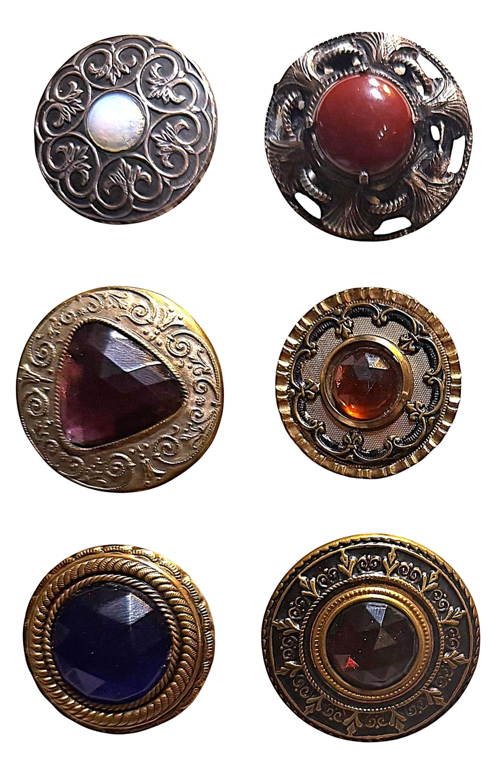 A SMALL CARD OF DIVISIO ONE LARGE JEWEL BUTTONS: 6 Large 19th/20tyh century examples including Gay 90's. This lot includes a large pierced brass Gay 90 example with a rust brown cabochon center glass jewel like stone along with 5 early 20th century