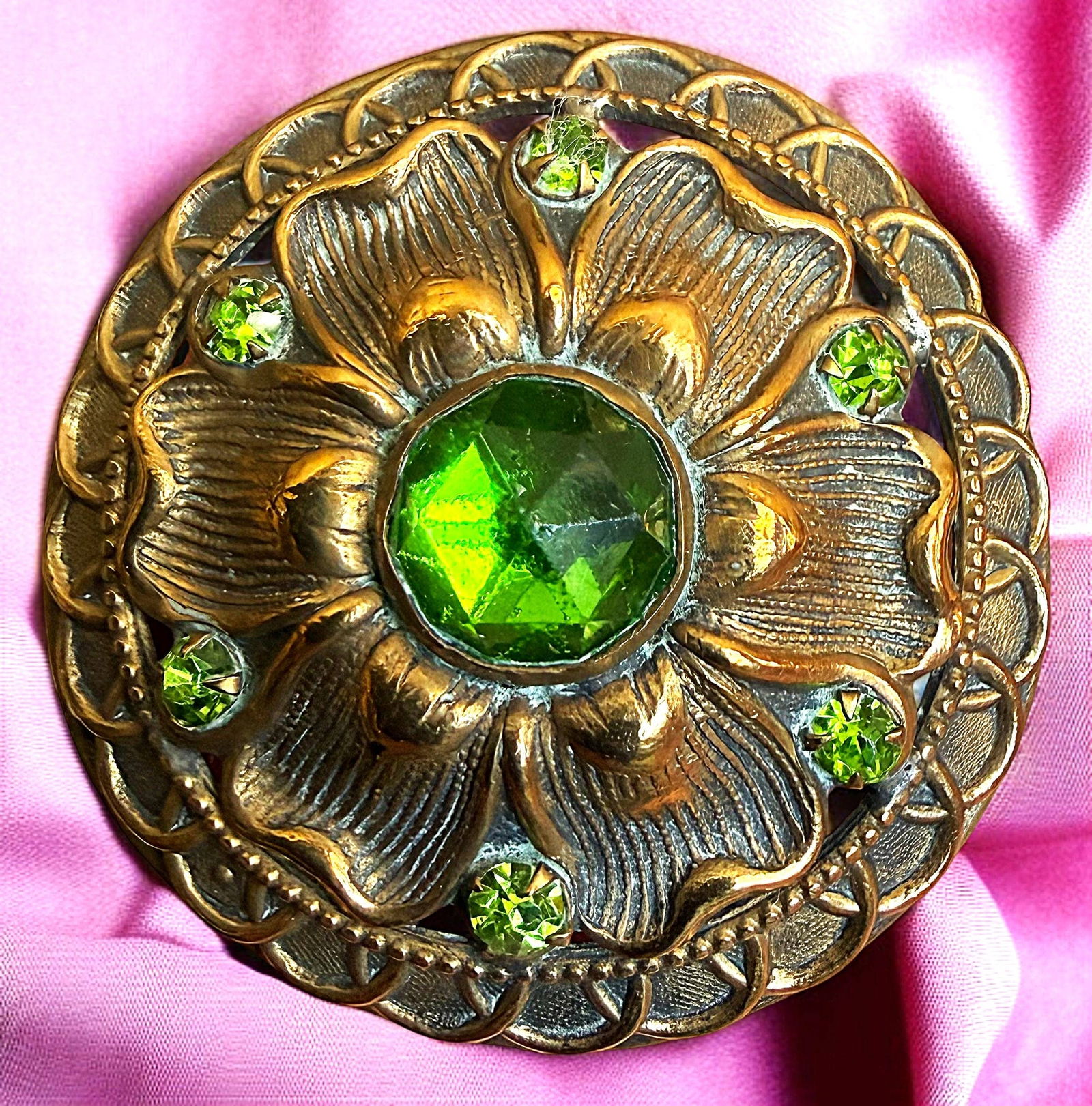 A DIVISION ONE LARGE ORNATE JEWELED BUTTON: 1 Large late 19th century Gay 90's example. Here is a beautiful and ornate detailed example of a genuine Gay 90 button. This example is a pierced example with a large faceted gemstone like glass cente