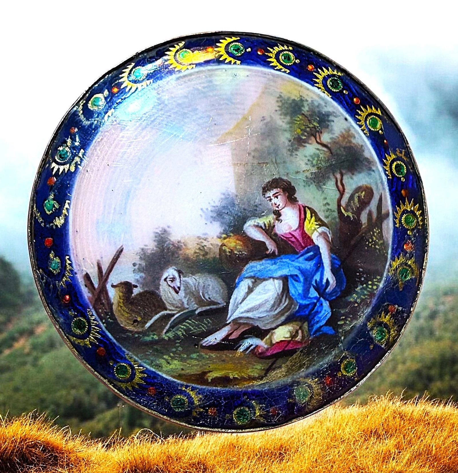 A DIVISION ONE FIGURAL ENAMEL BUTTON: 1 Large early 19th century foil enamel with a woman and sheep. This is an exquisite example of 19th century enamel work The center detailed hand painted design shows a colorful scene love a women sitt