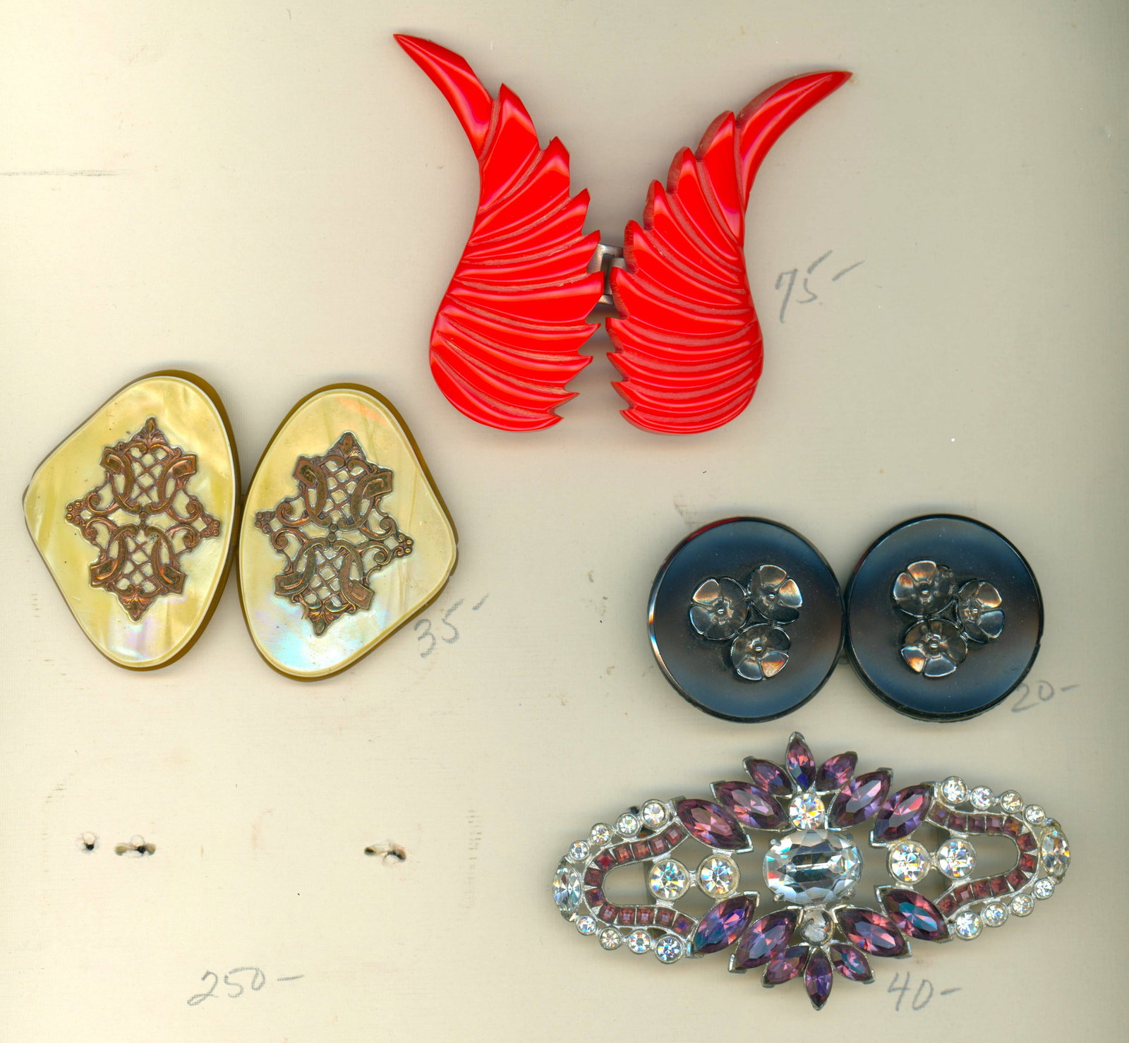 A PARTIAL CARD OF DIVISION ONE AND THREE BUCKLES: 4 Large 1 and 2 Piece 19th/20th C. Examples including Bakelite. This small selection packs a good punch of a couple of nice buckles. The lot includes a gorgeous and stunning "Glitzy" example of clear