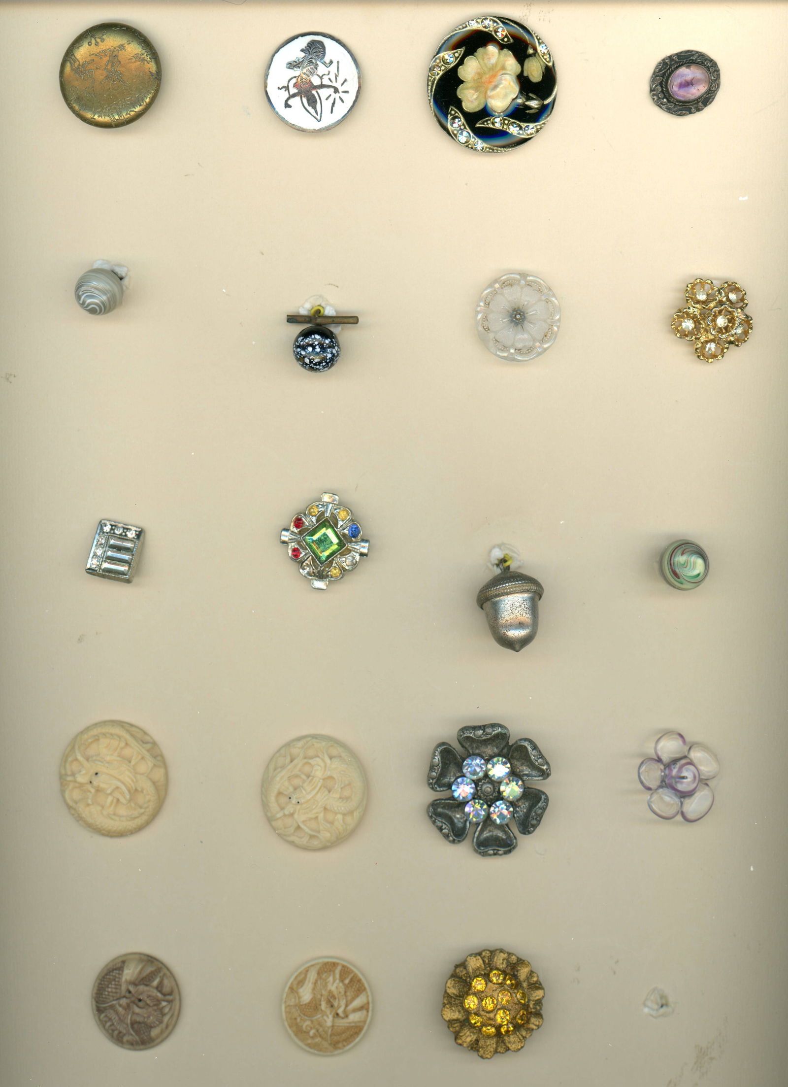 A CARD OF DIVISION 1 & 3 ASSORTED MATERIAL BUTTONS: 19 Medium/Small 19th/20th C. assorted techniques and styles. This card of Connie Robinsons includes two nice carved natural material dragons deeply carved, a nice large floral CPE and jewels, a harder