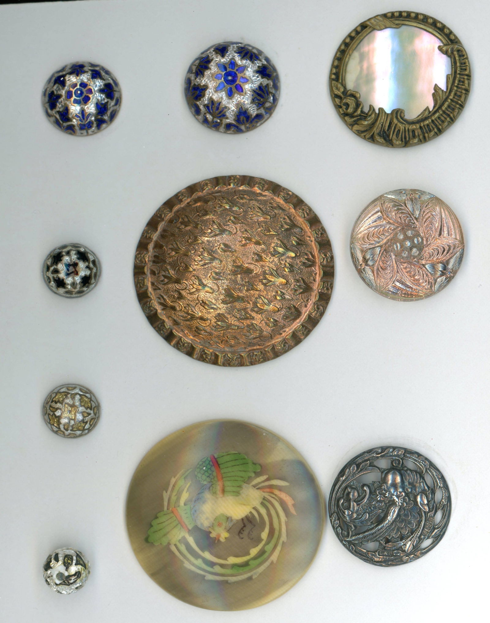 A CARD OF DIVISION 1 & 3 ASSORTED MATERIAL BUTTONS: 10 S/M/L/EX L 19th/20th C. including enamel and lacy glass. This is a small work card from the collection of Connie Robinson and includes 3 sizes of a scarce silvered foil style enamel, an extra large