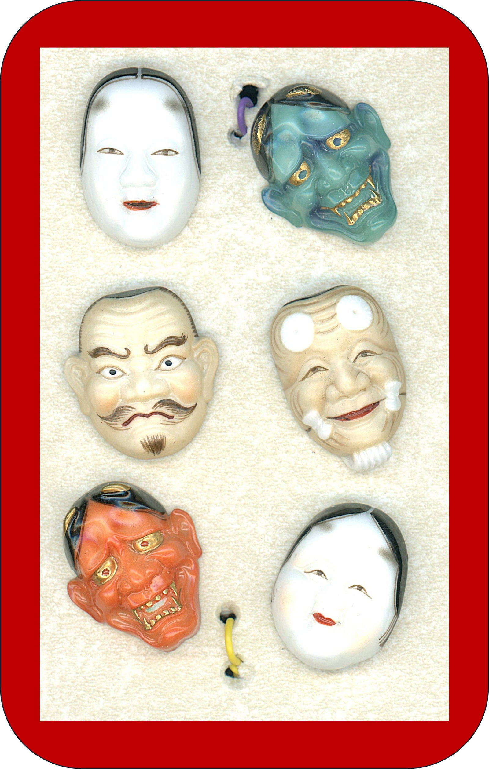 A SMALL CARD OF JAPANESE ARITA PORCELAIN BUTTONS: 6 Medium 20th century realistic shaped Noh Mask Examples. Here is a set of those mask buttons, not the 7 immortals, these are the Noh Masks and were made in Arita Japan by the Toshikane pottery compan