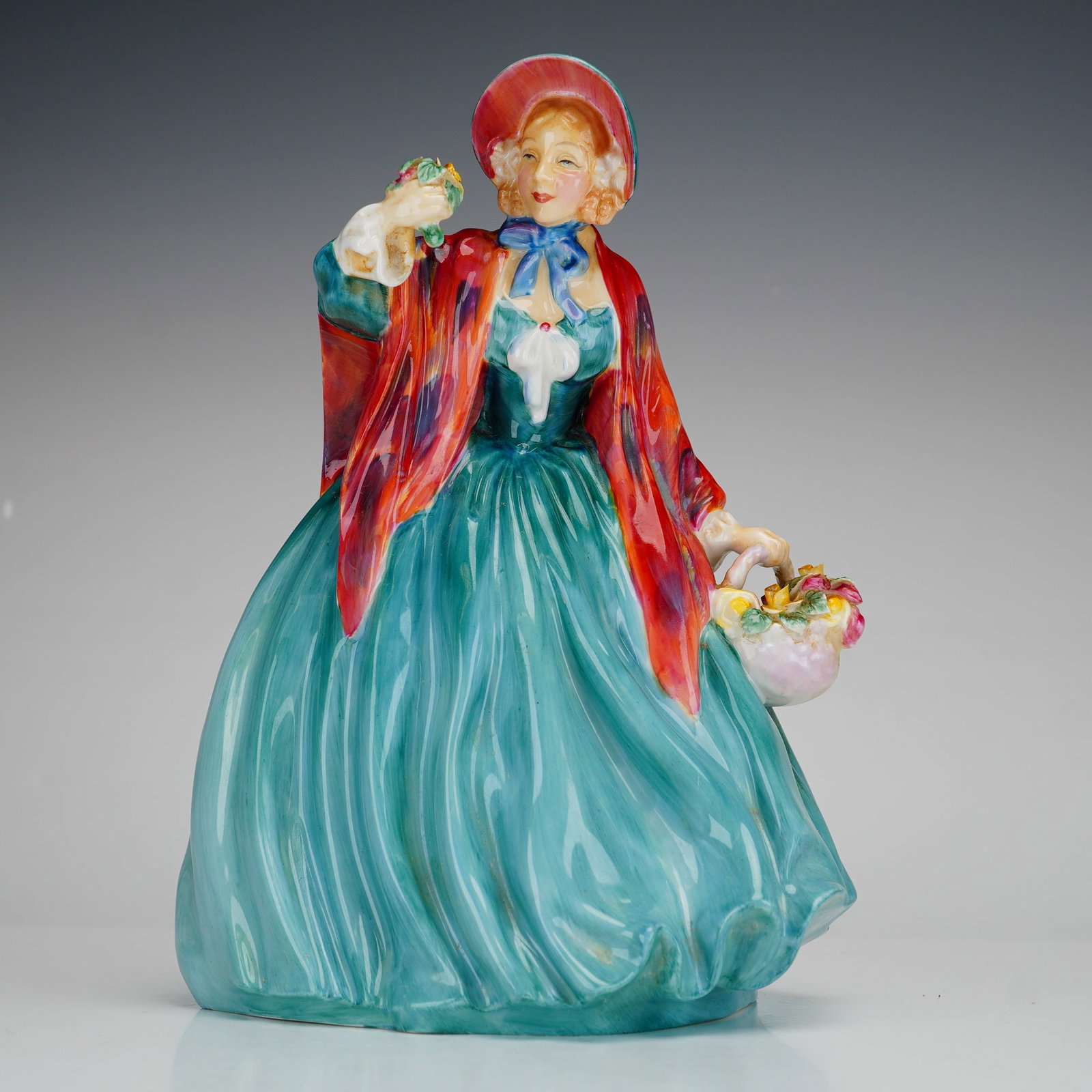 Royal Doulton, Lady Charmian HN 1948: A Royal Doulton bone china figurine titled Lady Charmian, model number HN 1948. This hand-painted figure depicts a woman in 18th-century style dress, featuring a voluminous turquoise green gown and a