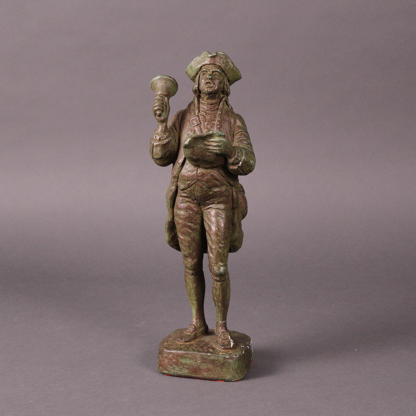 1964 Austin Productions Town Crier Figurine: An Austin Productions Town Crier figurine, dated 1964. This figurine depicts a standing male figure dressed in 18th to early 19th-century style clothing, including a tricorne hat, long coat, waistcoat