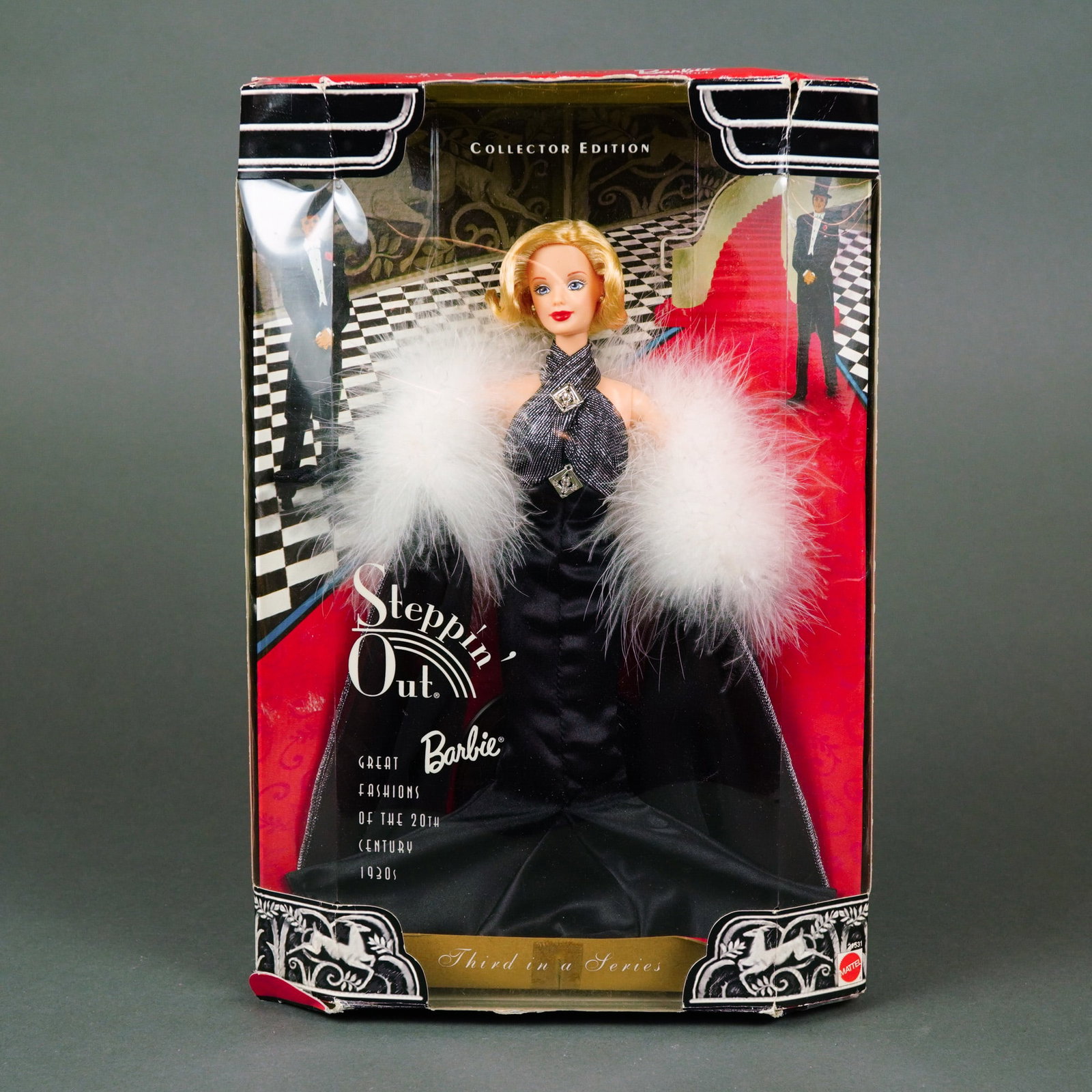 1930s Style Evening Gown, Steppin' Out Barbie Collector Edition, NRFB: This 1998 Collector Edition Barbie, titled "Steppin' Out," is the third release in the "Great Fashions of the 20th Century" series by Mattel. The ensemble authentically captures the high-glamour eveni
