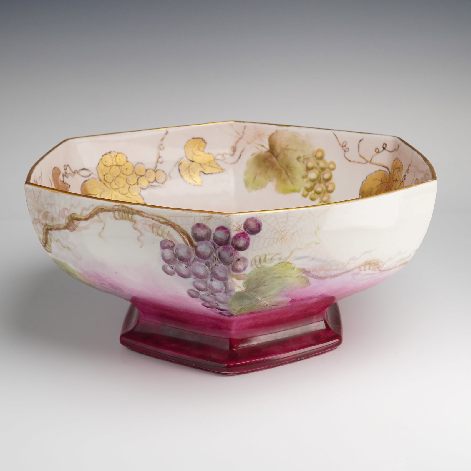 Tressemanes & Vogt Limoges Hand-Painted Grapevine Hexagonal Console Bowl: A large hard-paste porcelain hexagonal console bowl produced by Tressemanes & Vogt (T&V) of Limoges, France. This professional studio-painted piece features a continuous grapevine motif with clusters