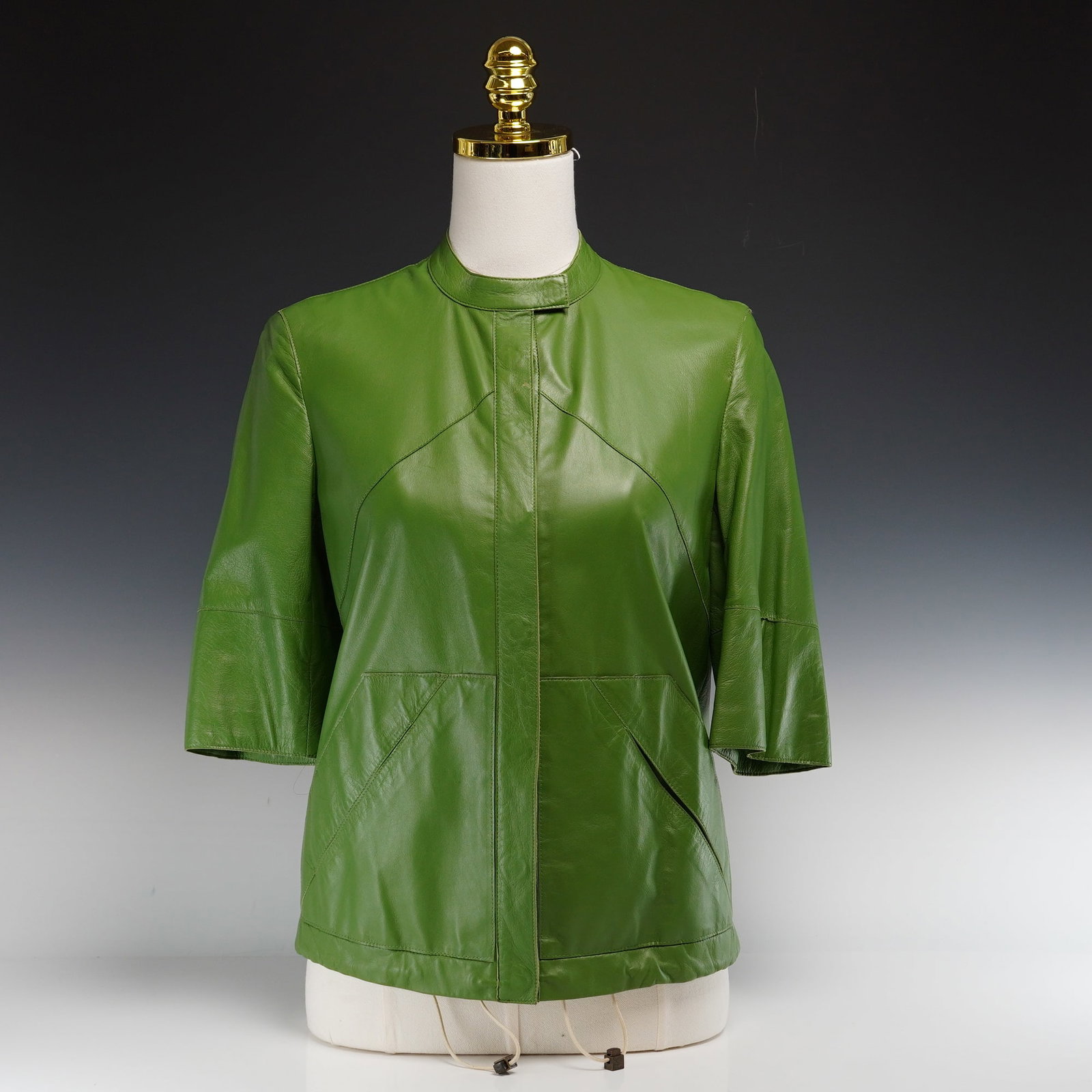 Akris Lammnappa Green Leather Short-Sleeved Jacket: A sophisticated contemporary leather jacket by Swiss luxury house Akris, crafted from premium grass green lammnappa (lambskin). This piece features a minimalist blouson silhouette with unique structur