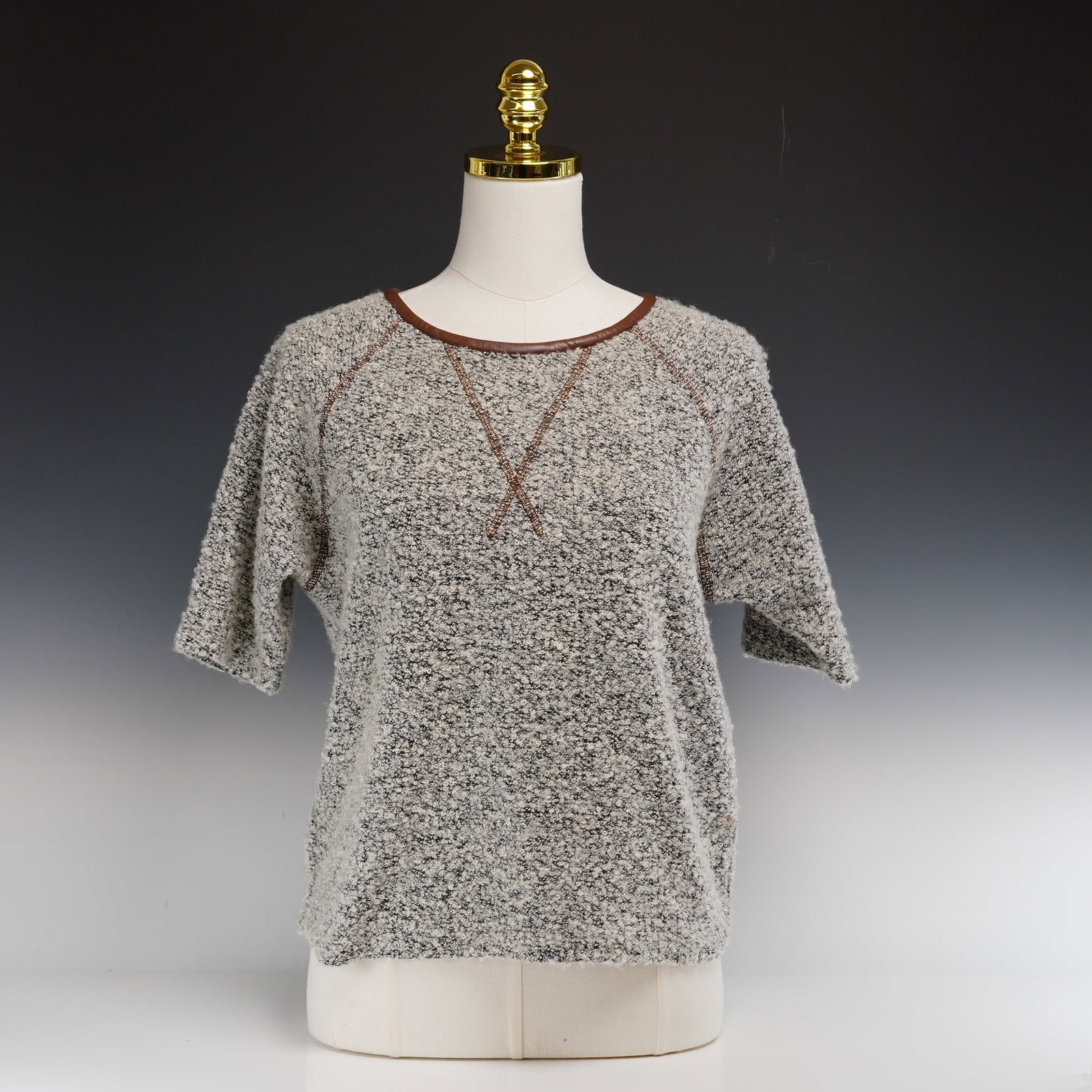 Ulla Johnson Polyester and Wool Short Sleeve Nubby Knit Sweater: This Ulla Johnson short-sleeved sweater is crafted from a heavy-weight polyester and wool blend textured bouclé knit. Presented in a mottled grey and ivory marl colorway, the garment features a boxy