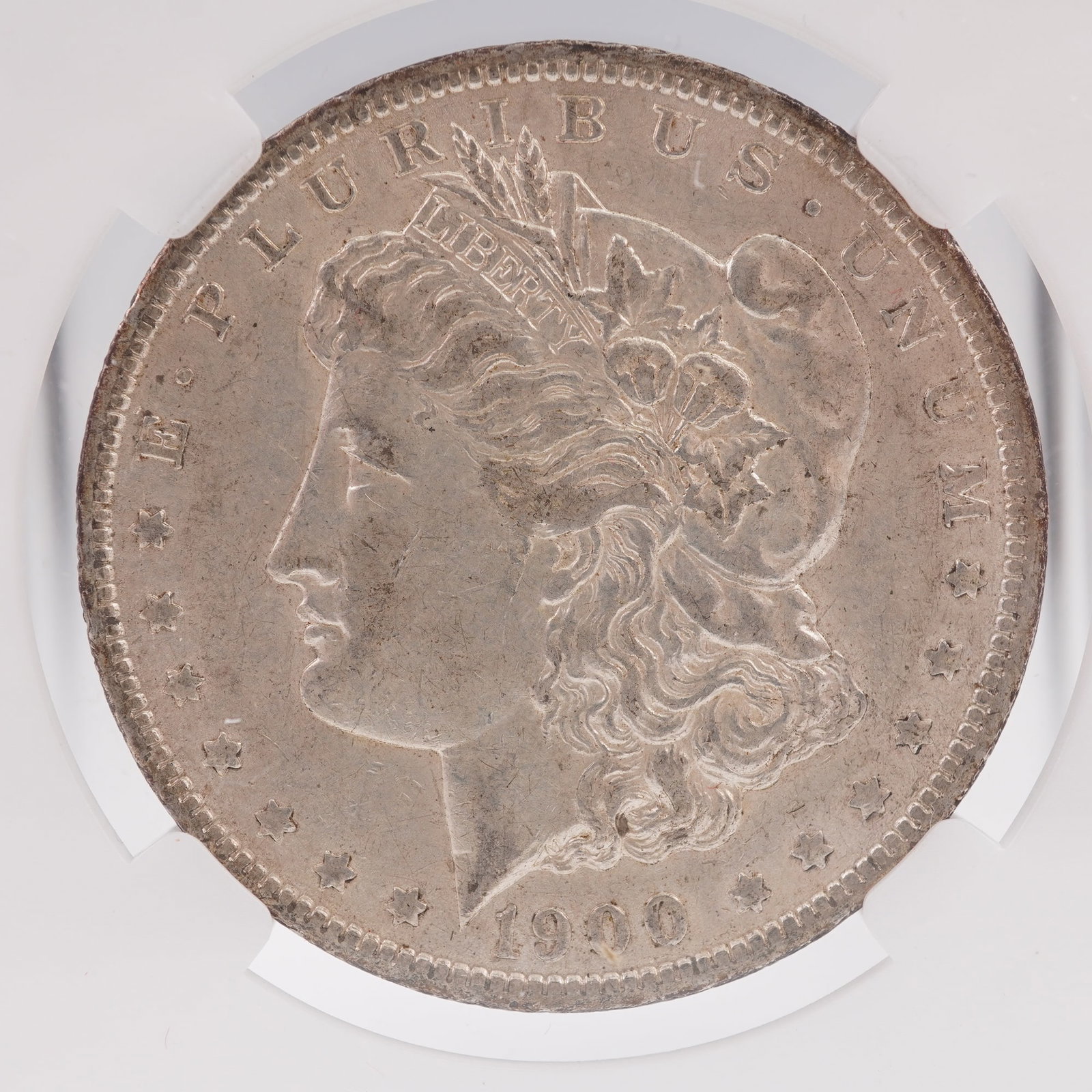 1900 Morgan Dollar Silver Coin New Orleans Mint Mark: The 1900 Morgan Dollar is struck in .900 fine silver and was designed by George T. Morgan. The obverse features Liberty wearing a coronet inscribed with LIBERTY, symbolizing freedom and enlightenment.