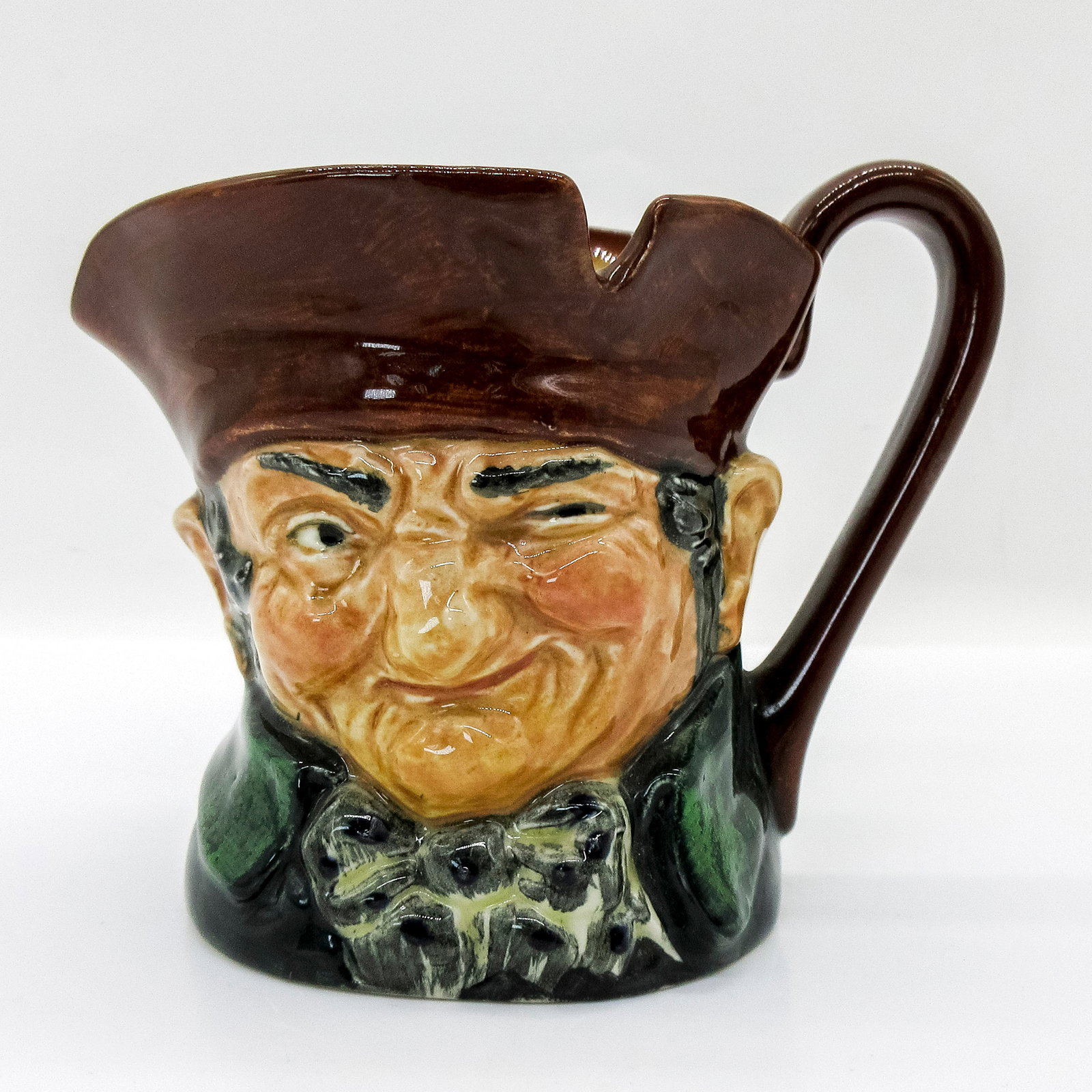 Old Charley D5527 - Small - Royal Doulton Character Jug: Brown hat; dark green coat; blue polka- dot bow tie. " Ten o'clock and all's well" was the familiar call of the Charlies, watchmen who originated during the reign of Charles II and were named after hi