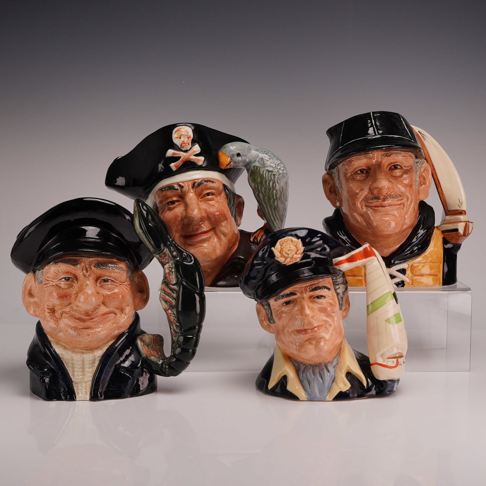 Four Royal Doulton Nautical and Pirate Theme Character Jugs: This collection consists of four Royal Doulton glazed earthenware character jugs featuring maritime and pirate subjects. Each piece is decorated with hand-painted details under a glossy glaze. The gro