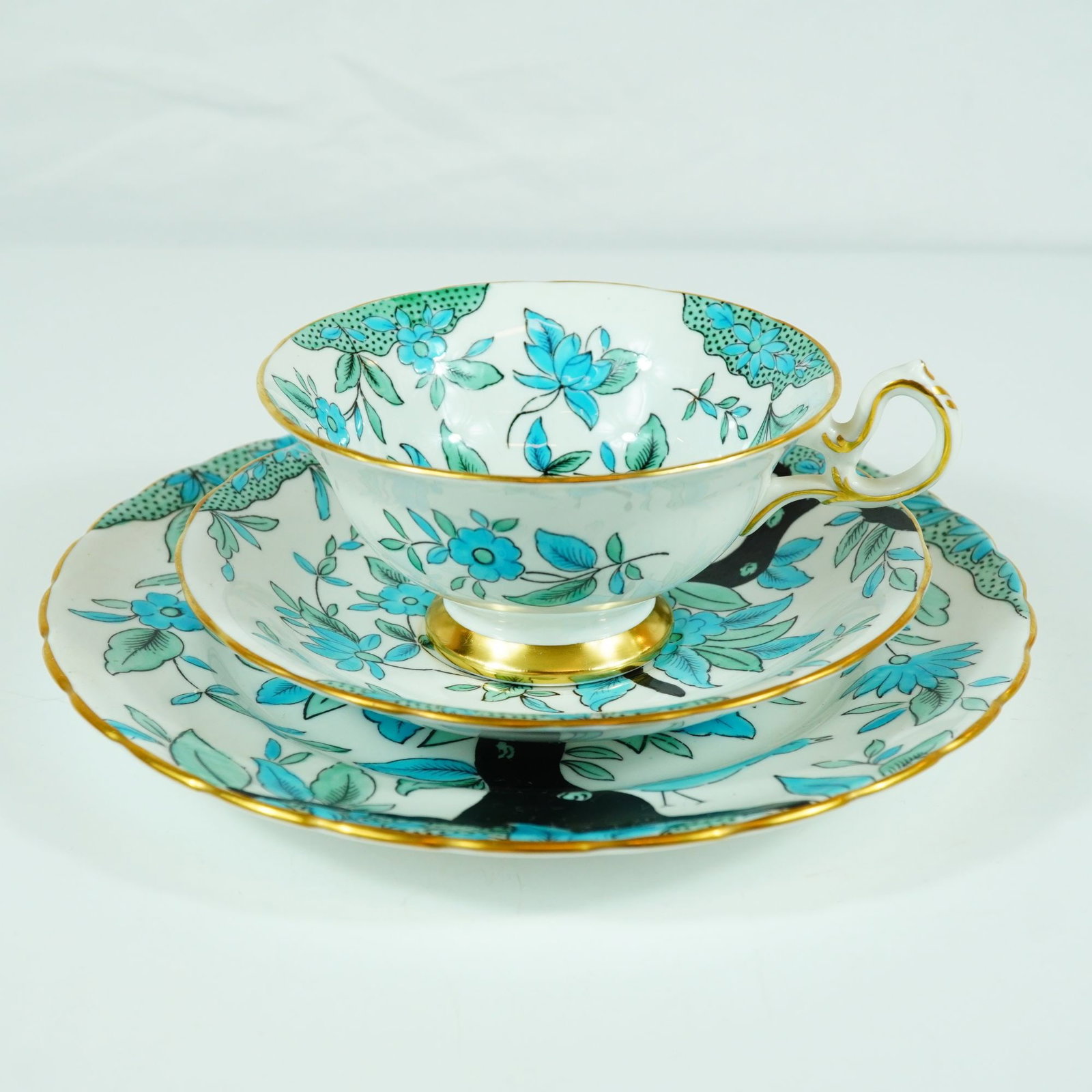 Royal Chelsea 663A Turquoise Enamel Floral and Gilt Bone China Tea Trio: A three-piece English bone china tea set, or trio, manufactured by Royal Chelsea. The set features the pattern 663A, a Chinoiserie-inspired design often referred to as a Tree of Life motif. The decora