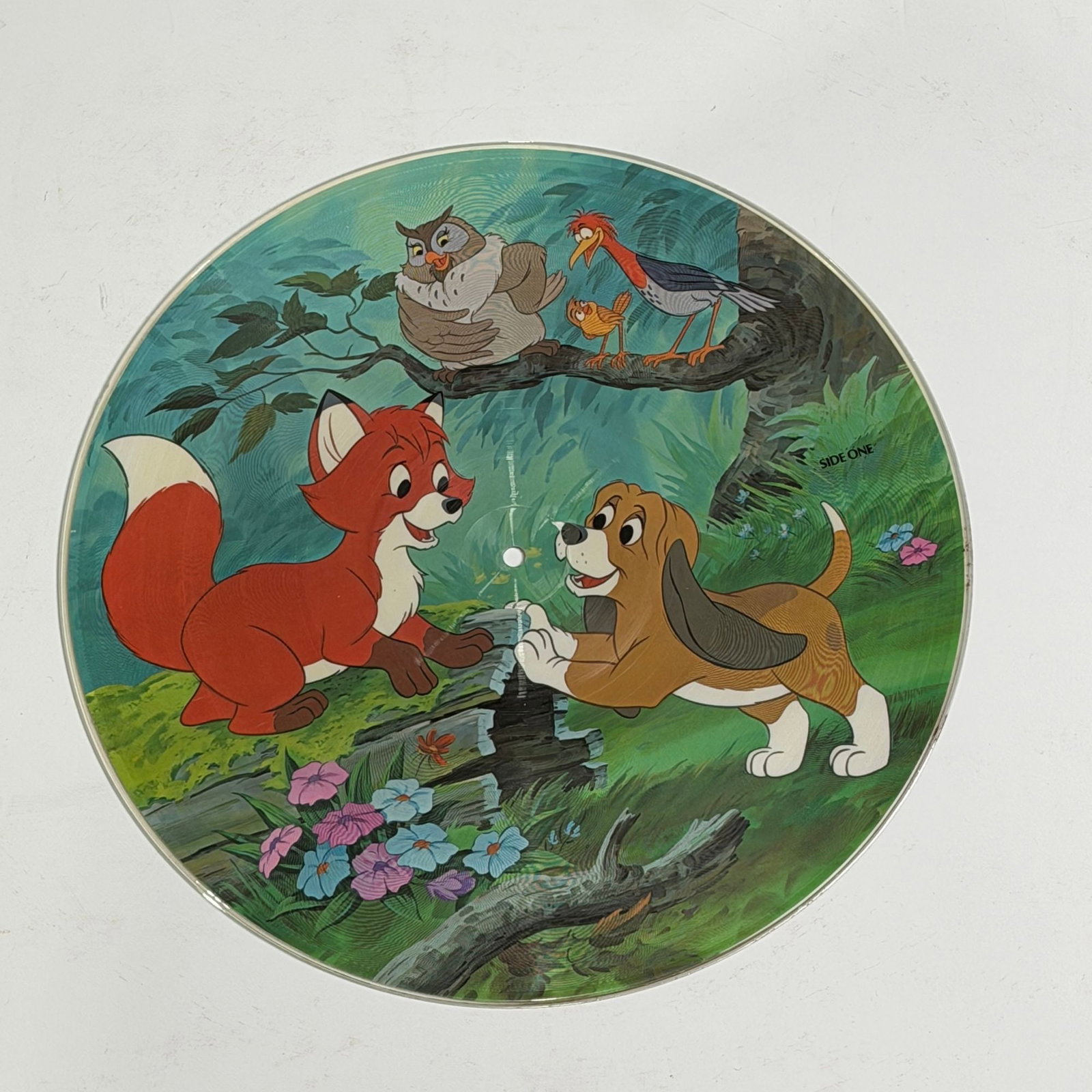 Walt Disney Productions The Fox and the Hound Vinyl LP Picture Disc, 1981: Produced by Walt Disney Productions, this 12-inch vinyl LP picture disc features the soundtrack and story elements from the 1981 animated feature film The Fox and the Hound. The disc is constructed of