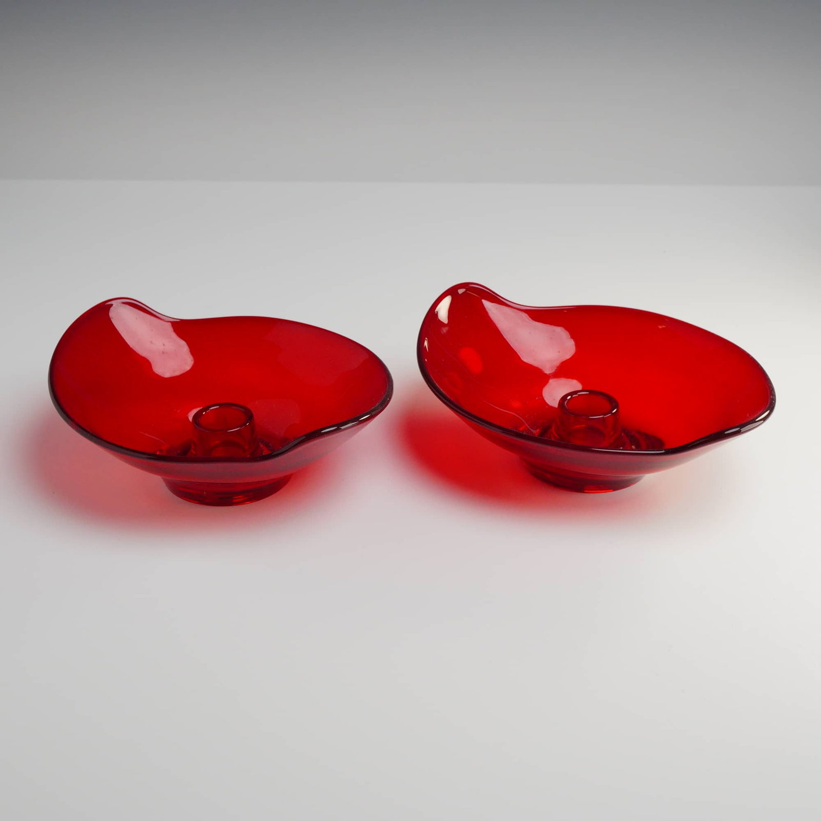 Viking Glass, Epic Line Ruby Red Art Glass Candle Holder Bowls: A pair of mid-century modern Viking Ruby Red glass candle holder bowls from the iconic Epic line, specifically model number 7300. These pieces are executed in a vibrant, deep ruby red color with excep
