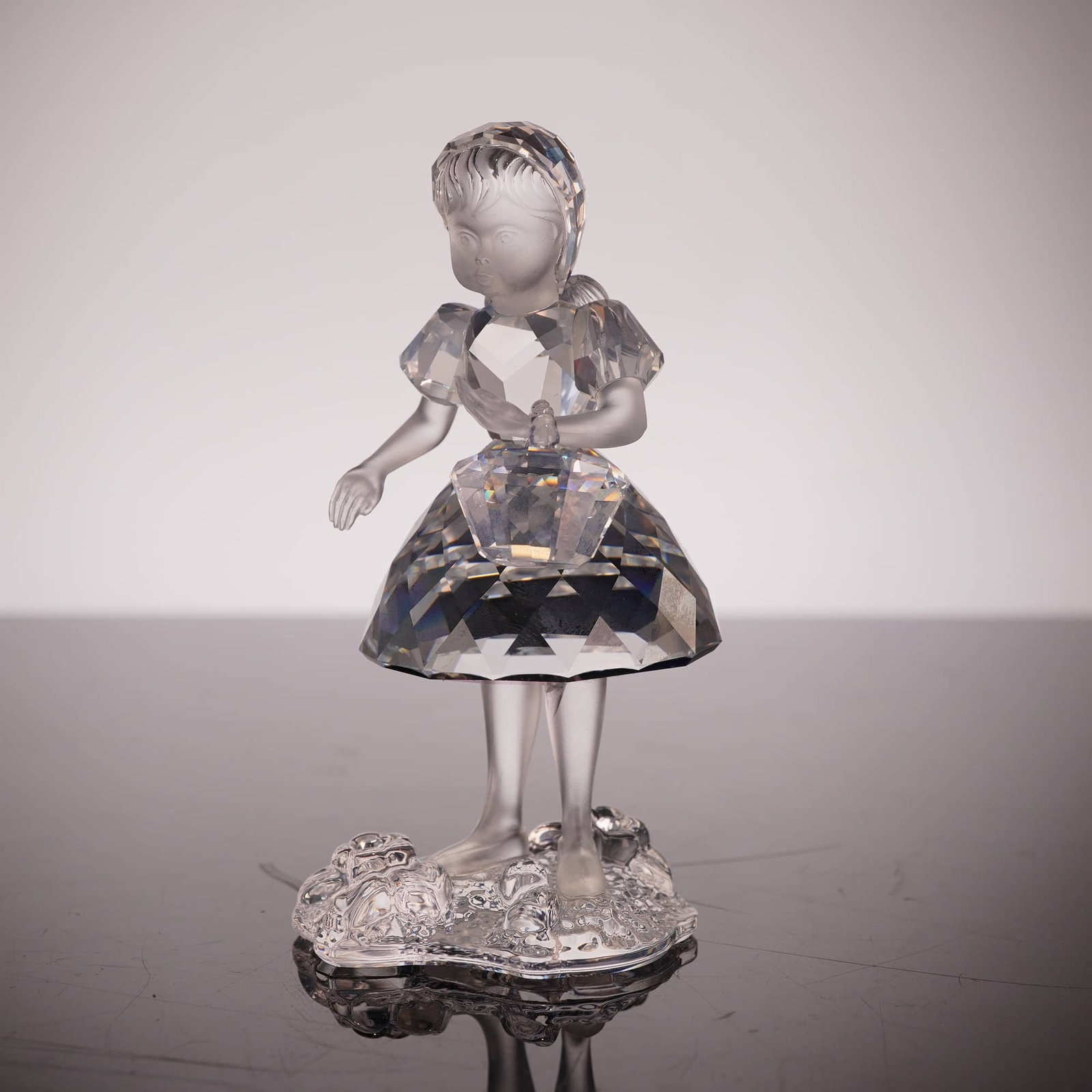 Swarovski Little Red Riding Hood Figurine 191695: Swarovski Silver Crystal figurine titled Little Red Riding Hood from the Fairy Tales theme group. Designed by Edith Mair, the piece is crafted from faceted and frosted lead crystal, depicting a young