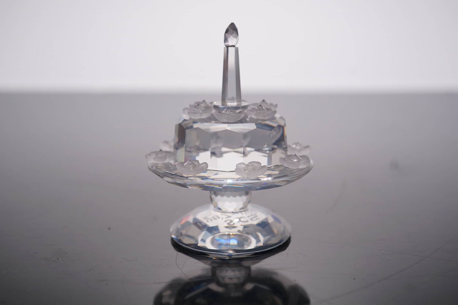 Swarovski SCS 5th Anniversary Birthday Cake Figurine: A commemorative Swarovski Crystal Society (SCS) lead crystal figurine titled Birthday Cake, produced in 1992 to mark the 5th anniversary of the society. The piece features a two-tier faceted clear cry