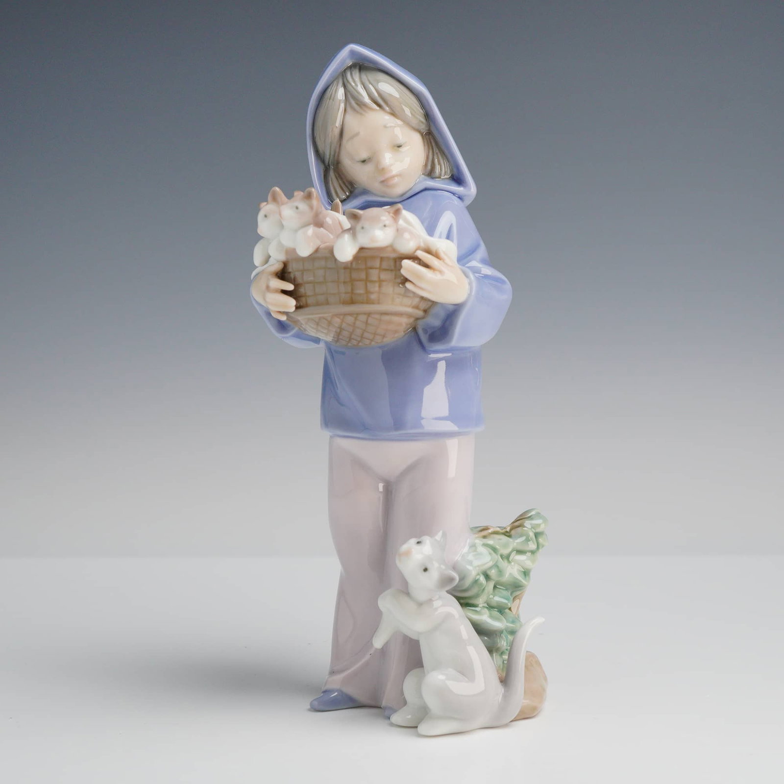 Lladró Mother's Little Helper Porcelain Figurine, Model 6102: A professional Lladró porcelain figurine titled Mother's Little Helper (Nina con Gatitos), model number 6102. This charming piece, designed by sculptor Juan Huerta, depicts a young girl in a contempl