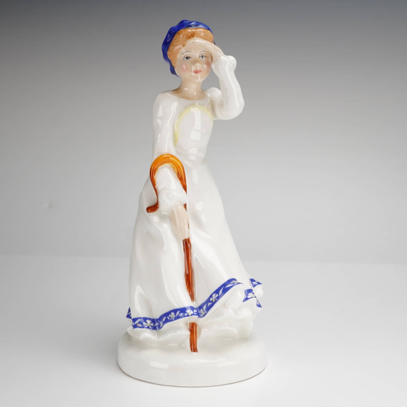 Royal Doulton Little Bo-Peep HN3030 Nursery Rhymes Collection Figurine: A Royal Doulton bone china figurine titled Little Bo-Peep, model HN3030, from The Nursery Rhymes Collection. This hand-decorated piece was modeled by Adrian Hughes and depicts the character in a flowi