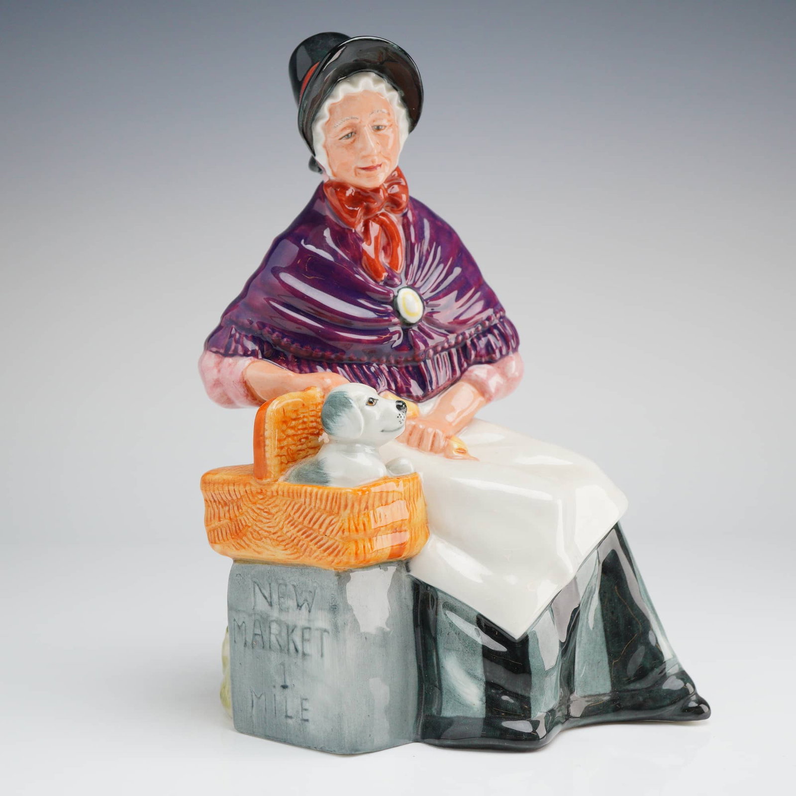 Royal Doulton Porcelain Figurine, New Companions HN2770: This Royal Doulton glazed porcelain figurine, titled New Companions (model H.N. 2770), depicts an elderly woman in Victorian-style attire. She is shown wearing a black bonnet with a red ribbon, a purp