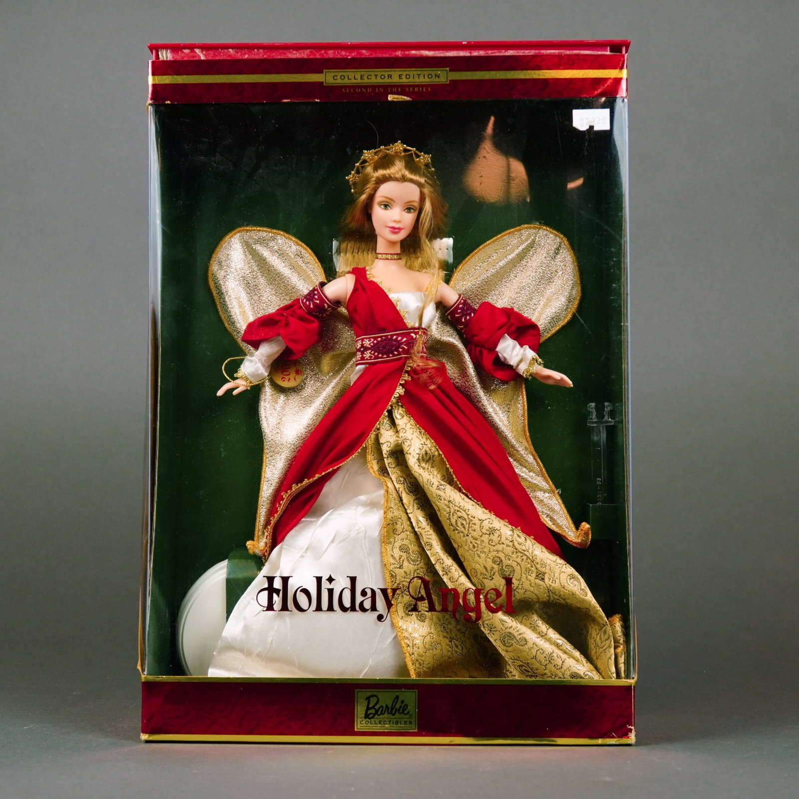 Mattel, Holiday Angel Barbie Doll Collector Edition, 12 Inches: Manufactured by Mattel, Inc., this vinyl fashion doll is the second release in the Holiday Angel series. The doll features rooted, long, wavy light brown hair and fixed, painted green eyes with detail