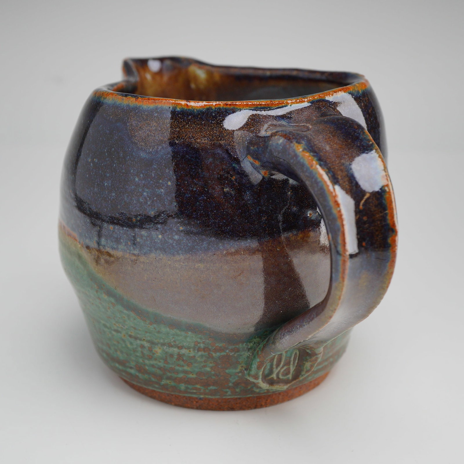 Linda DeBoer Studio Art Pottery Jug: Handcrafted studio ceramic jug by Tucson, Arizona artist Linda DeBoer. This organic-form vessel features a softly rounded body with a free-flowing, asymmetrical mouth and applied handle. The surface