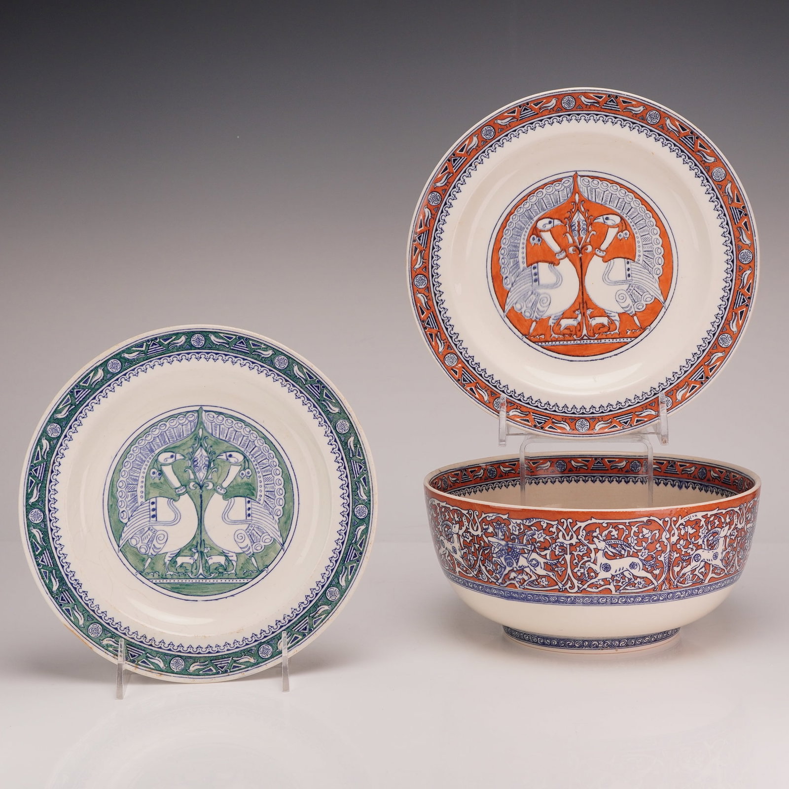 3pc Wedgwood Persian Style Ceramic Plates and Bowl: This trio of earthenware pieces was manufactured by Wedgwood, exhibiting a stylized Iznik or Persian-inspired design. The collection consists of one large, deep circular bowl with a raised foot ring a