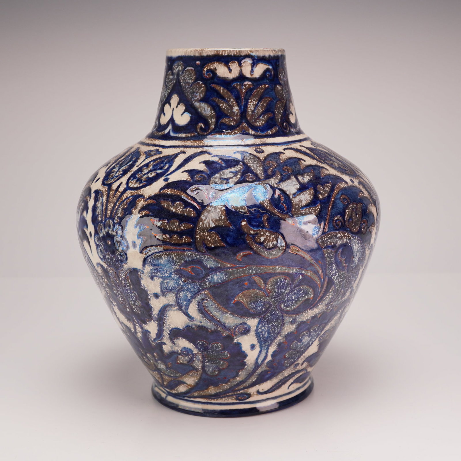 Bushey Heath Fred Passenger Persian Style Luster Earthenware Vase: This baluster-form earthenware vase features hand-painted luster decoration in a Persian-inspired style. The exterior is decorated with dense, stylized foliate and floral designs in shades of cobalt b