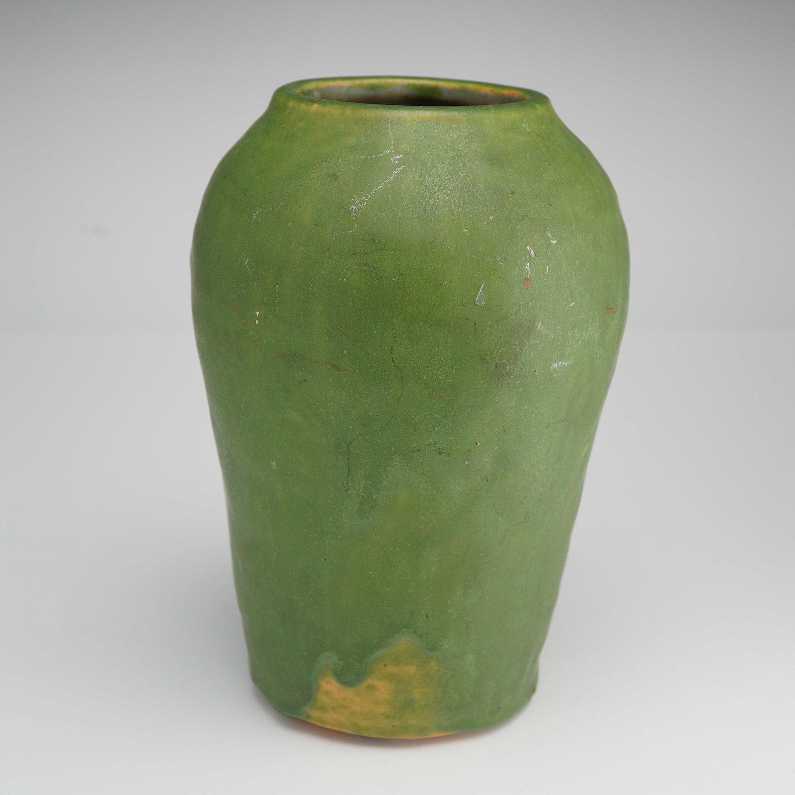 Art Studio Green Drip Glaze Pottery Vase: Hand-thrown stoneware vase featuring a gently tapered cylindrical form with a slightly flared rim. The surface is finished in a thick, matte green glaze with subtle drip accents pooling near the base,