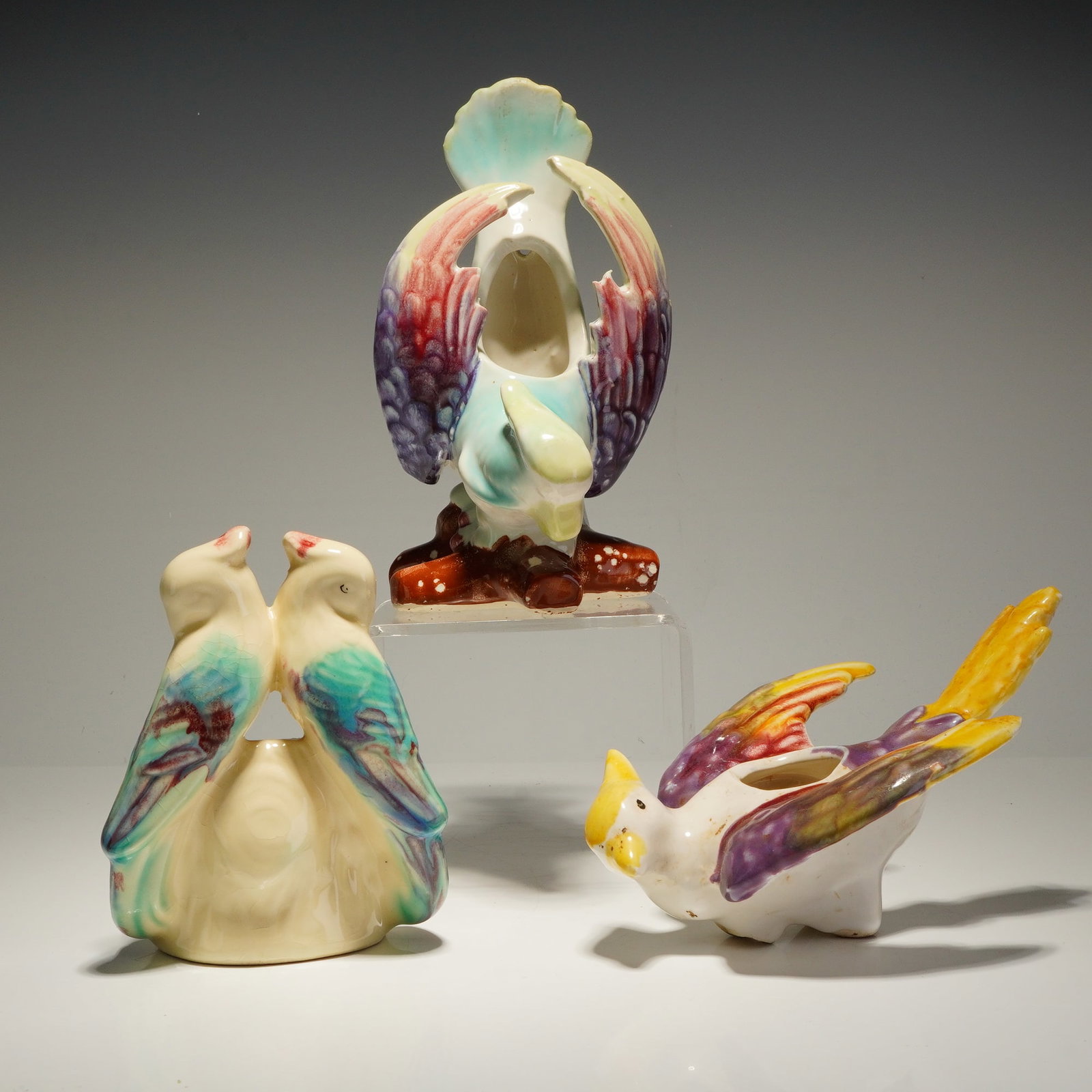 Three Morton Pottery Bird Shaped Planters: A trio of Morton Pottery bird shaped planters featuring raised relief accents and a polychrome finish. This collection of glazed earthenware objects includes a tall wall pocket planter, a small plante