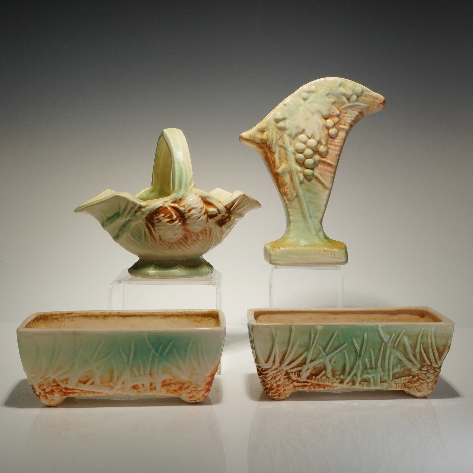 4pc McCoy Pottery Rustic Line Pine Cone Pattern Planters and Vases: A 4pc collection of McCoy Pottery from the Rustic Line featuring the Pine Cone pattern. The group consists of various sizes and shapes, including two rectangular trough planters, a handled basket, and