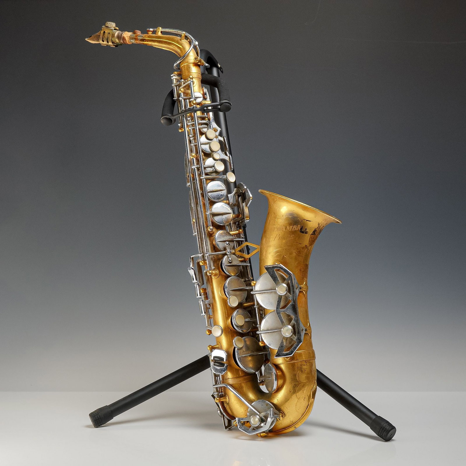 LaChambre Paris Etched Brass Alto Saxophone with Otto Reed: This alto saxophone is manufactured by LaChambre of Paris, France. The instrument features a brass body with a gold-colored lacquer finish and silver-toned metal keywork. The bell is decorated with an