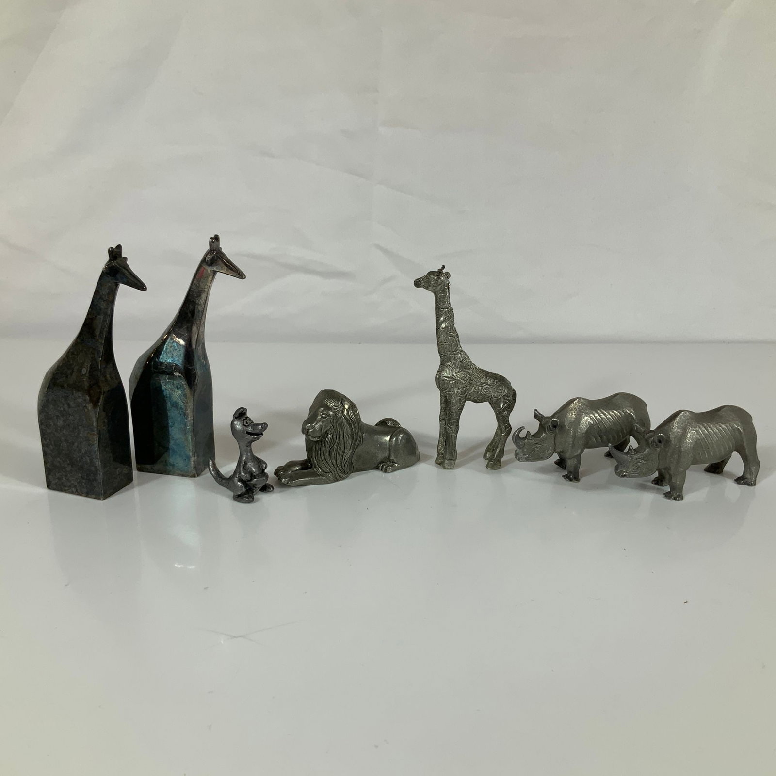 7pc Collection of Kirk Pewter and Gunnar Cyren for Dansk Silver-Plated Animal Figurines: This collection consists of seven animal figurines including pieces by Kirk Pewter and Gunnar Cyren for Dansk Designs. The group contains three cast pewter figurines by Kirk Pewter, consisting of a re