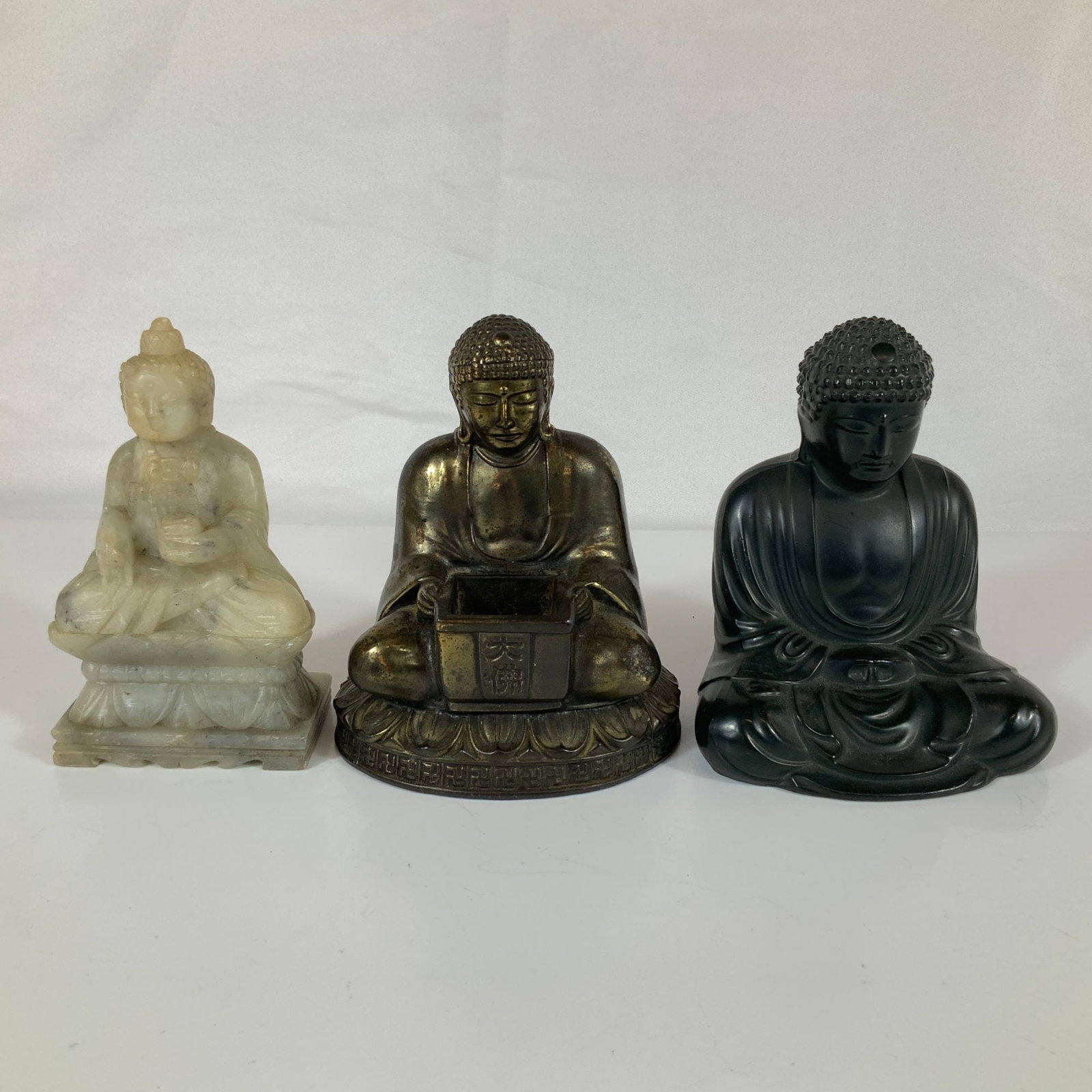 Three Stone and Metal Seated Buddha Figurines (1 of 3)