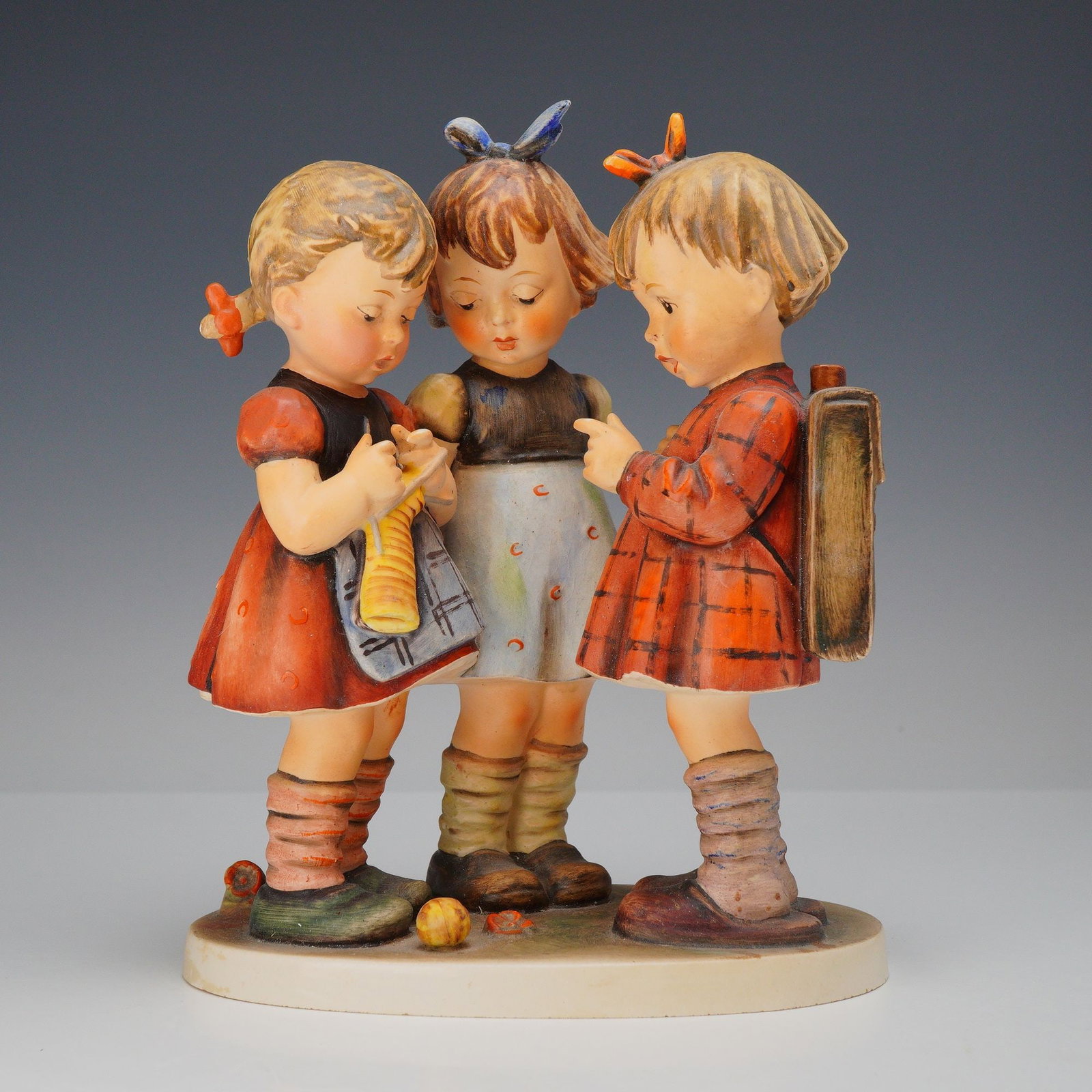 Goebel M.I. Hummel Figurine, School Girls Hum 177/I: This hand-painted ceramic figurine, titled "School Girls" (also known as "The Three Girls"), is a quintessential example of the work produced by Goebel based on the illustrations of Sister Maria Innoc