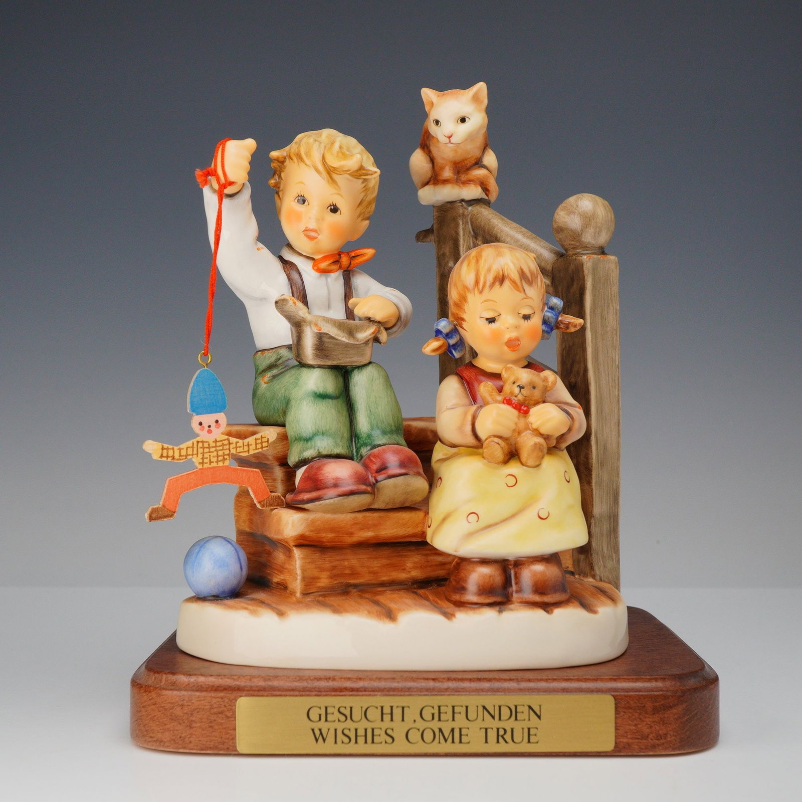 Goebel Hummel, Wishes Come True Figurine with Base: A large-scale Goebel Hummel porcelain figurine titled Wishes Come True (German title: Gesucht, Gefunden), model number 2025/I. This piece is part of the Wonder of Childhood (Kindheitstr?ume) series an