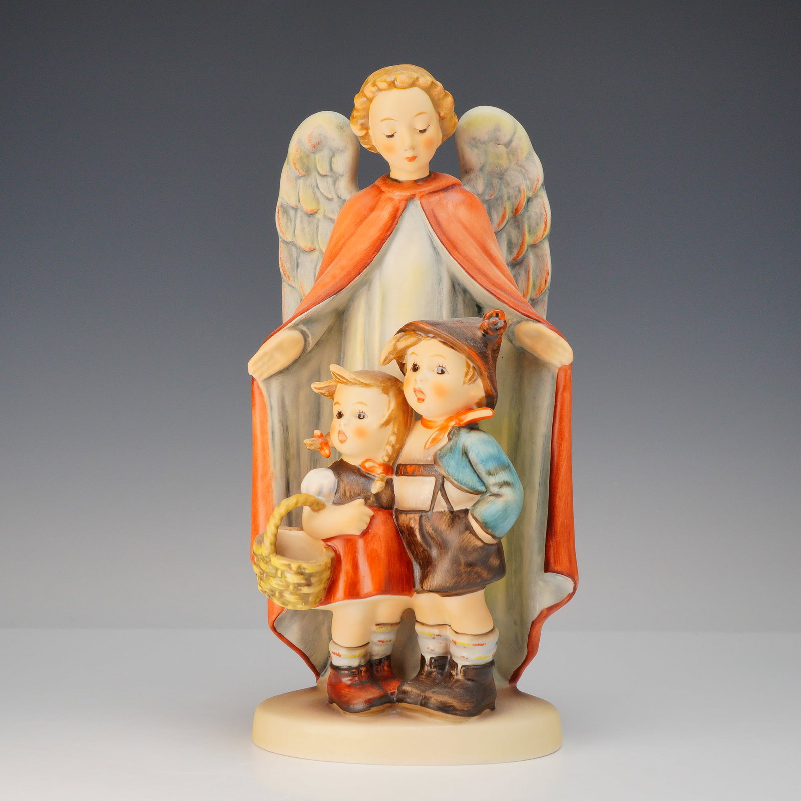 Goebel Hummel Heavenly Protection Figurine: This hand-painted ceramic figurine, titled Heavenly Protection and Schutzengel, is produced by the Goebel factory and attributed to the designs of Sister Maria Innocentia Hummel. The piece depicts a g