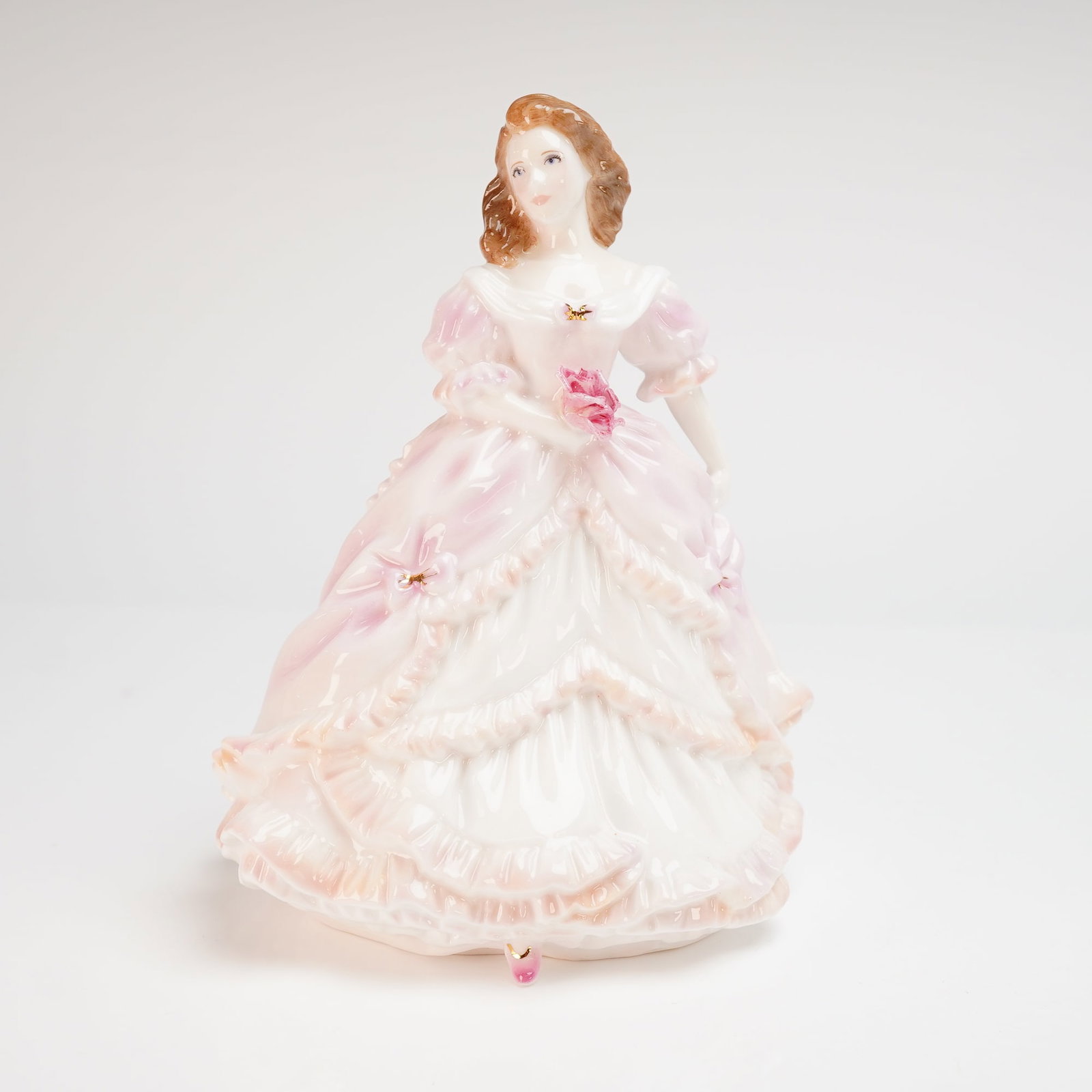 Royal Worcester Bone China Figurine Bridesmaid: A Royal Worcester fine bone china figurine titled Bridesmaid from the Golden Moments collection. This piece was modeled by Maureen Halson and is dated 1996. The figurine depicts a young woman with wav