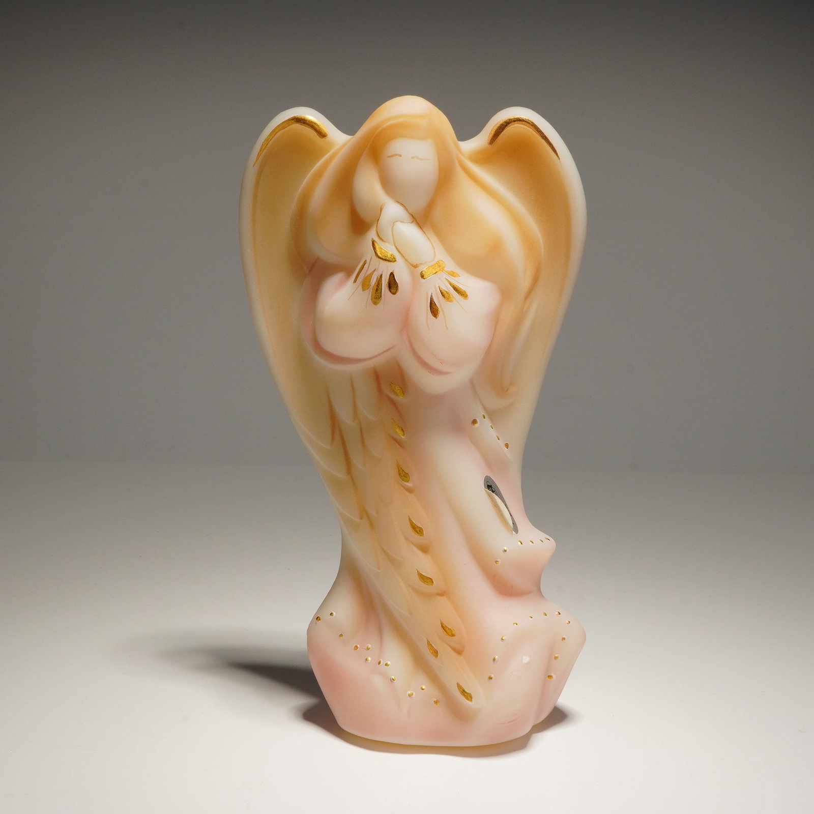 Fenton Radiant Angel Figurine: A Fenton Radiant Angel Figurine model number 5542HJ, featuring peach and pink opalescent glass with gold details, airbrushed by Mike Husk and handpainted by S. Shephard, marked #1316, and presented wi