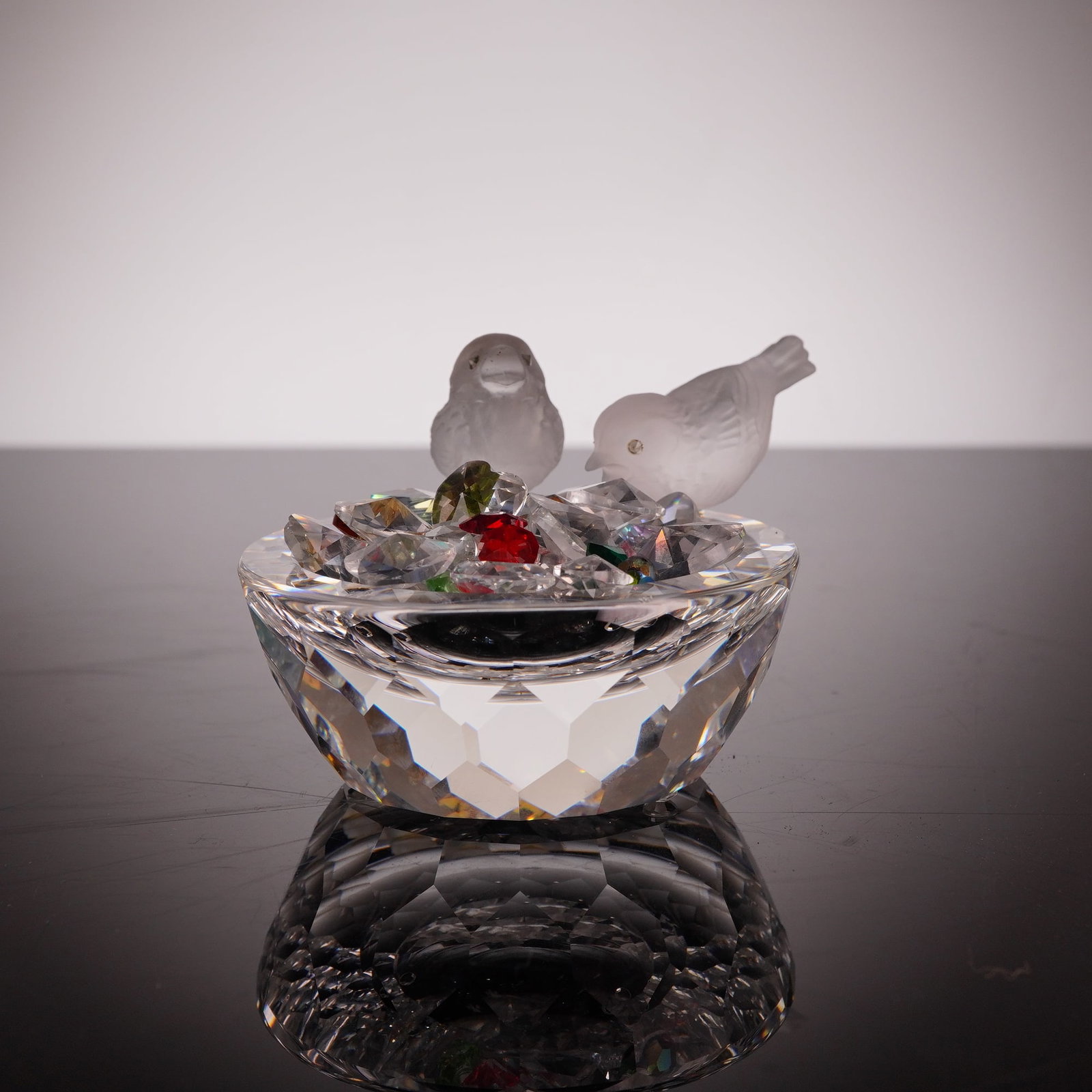 Swarovski Crystal Bird Bath 10029: This Swarovski crystal figurine, titled Bird Bath (model number 10029 / 7460 NR 108), is a retired piece from the Feathered Beauties collection. The design features a brilliant, faceted clear crystal