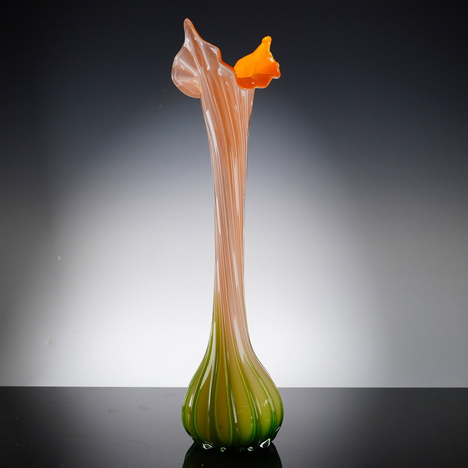 Murano-Style Hand-Blown Jack-in-the-Pulpit Art Glass Vase: The vase is crafted in the Jack-in-the-Pulpit style, featuring a vibrant color gradient that transitions from a saturated orange rim to a green base. The piece exhibits a bulbous, vertically ribbed ba