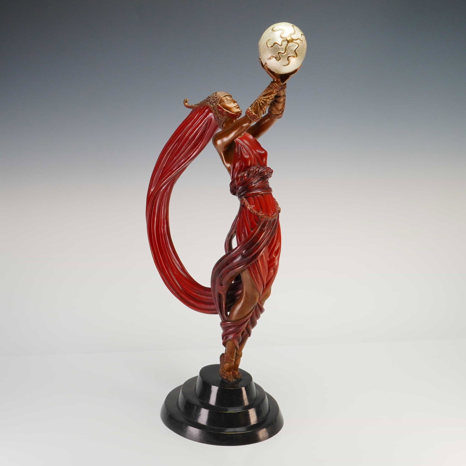 Erte (Romain de Tirtoff) Bronze Sculpture, The Globe: This limited edition polychrome and cold-painted bronze sculpture is titled The Globe, by the artist Erte (Romain de Tirtoff). The work features a stylized female figure in the Art Deco tradition, wea
