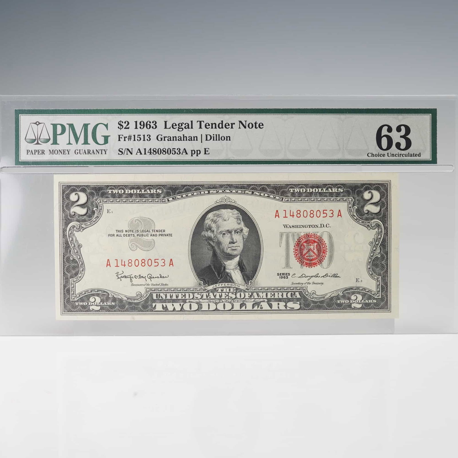 1963 U.S. Two Dollars Legal Tender Note - Fr 1513 Granahan/Dillon: $2 Legal Tender Note, cataloged as Friedberg #1513, graded PMG Choice Uncirculated 63. The obverse features a portrait of Thomas Jefferson at center with vivid red serial numbers and Treasury seal, an