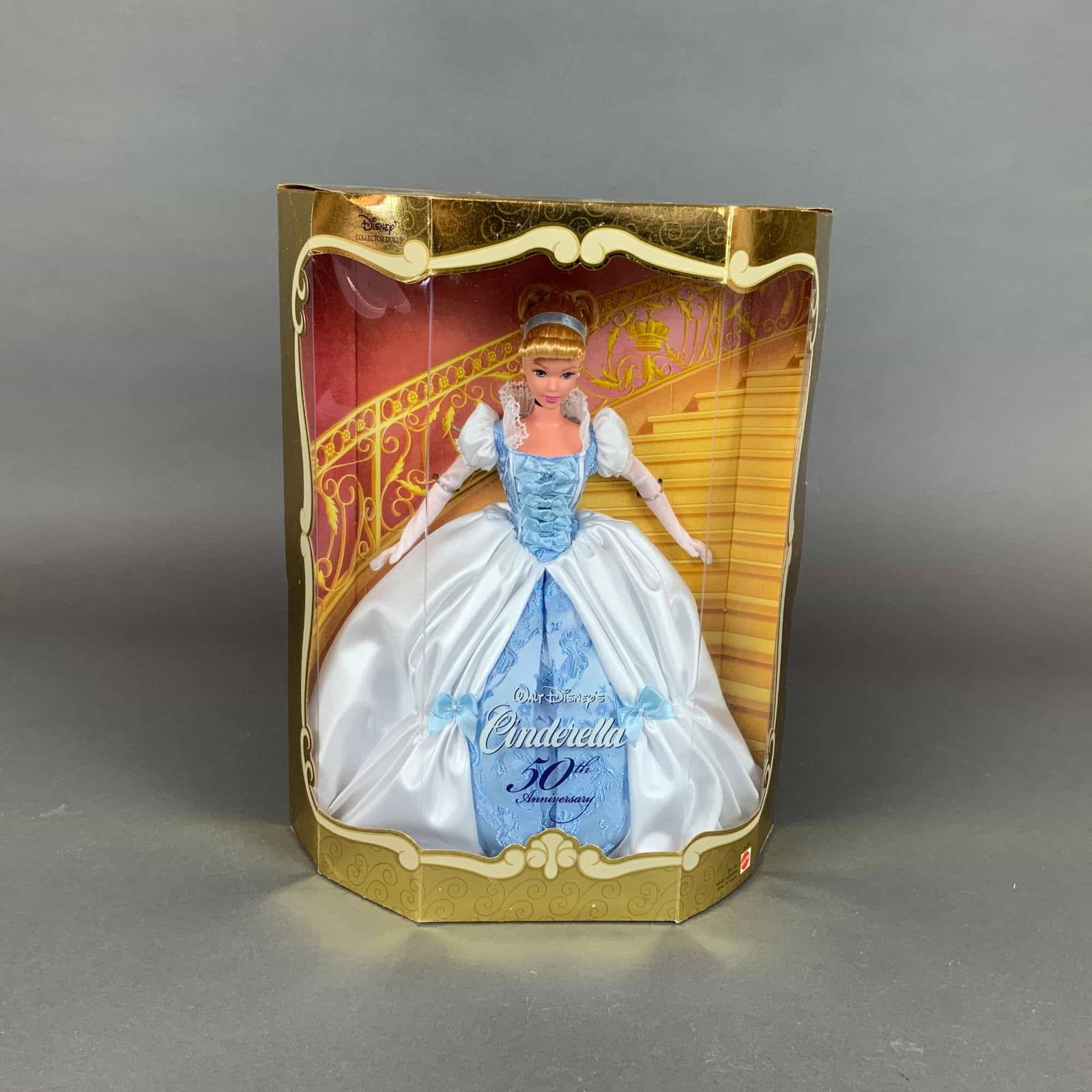 Walt Disney's 50th Anniversary Cinderella Collector Doll 1999 Mattel No. 26291: This collector doll was manufactured by Mattel, Inc. in 1999 to commemorate the 50th anniversary of Walt Disney's Cinderella. The doll features a vinyl body with painted facial features and rooted blo
