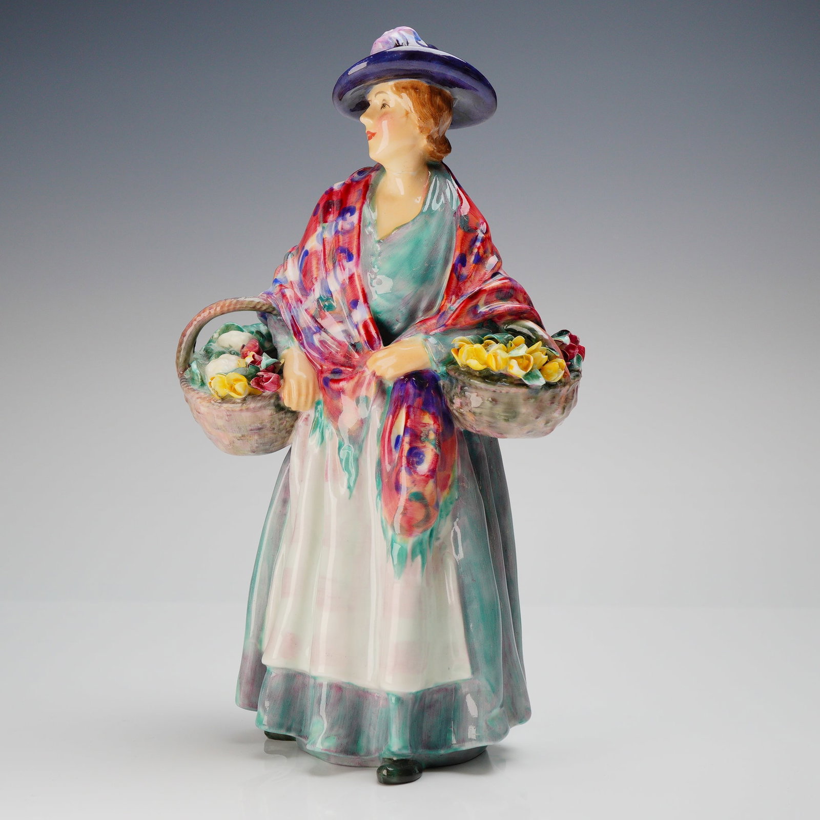 Royal Doulton Bone China Romany Sue Figurine HN1757: A Royal Doulton Romany Sue Figurine, model number HN1757, designed by Leslie Harradine (active period 1936-1949). This single glazed porcelain figurine depicts a standing female figure, known as Roman