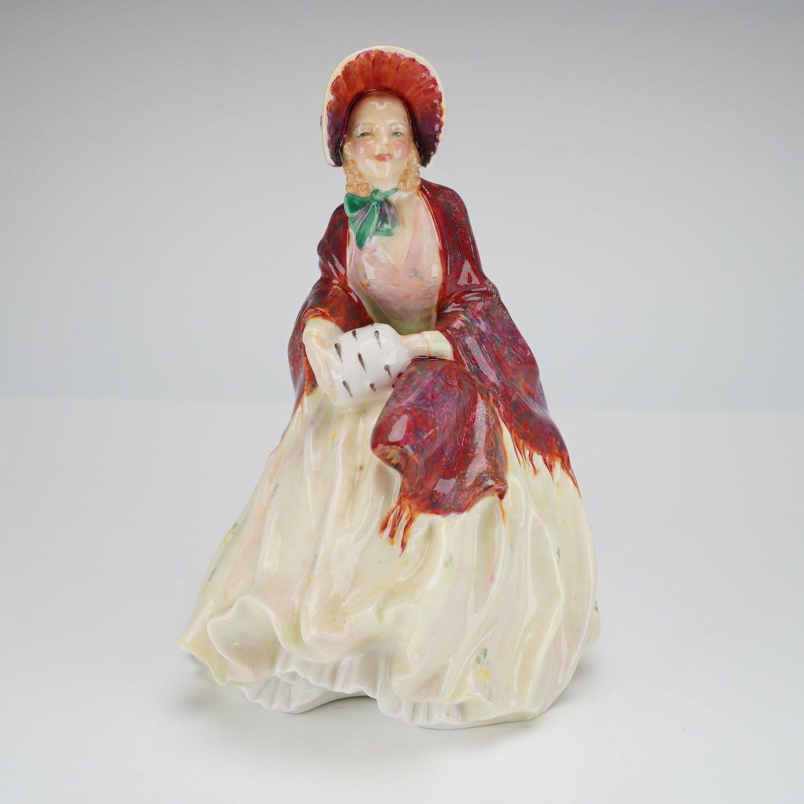 Royal Doulton Porcelain Figurine Her Ladyship HN1977: A Royal Doulton hand-painted and glazed porcelain figurine, titled Her Ladyship, model number HN1977. The figure depicts a female character in period attire, wearing a ruffled cream skirt decorated wi