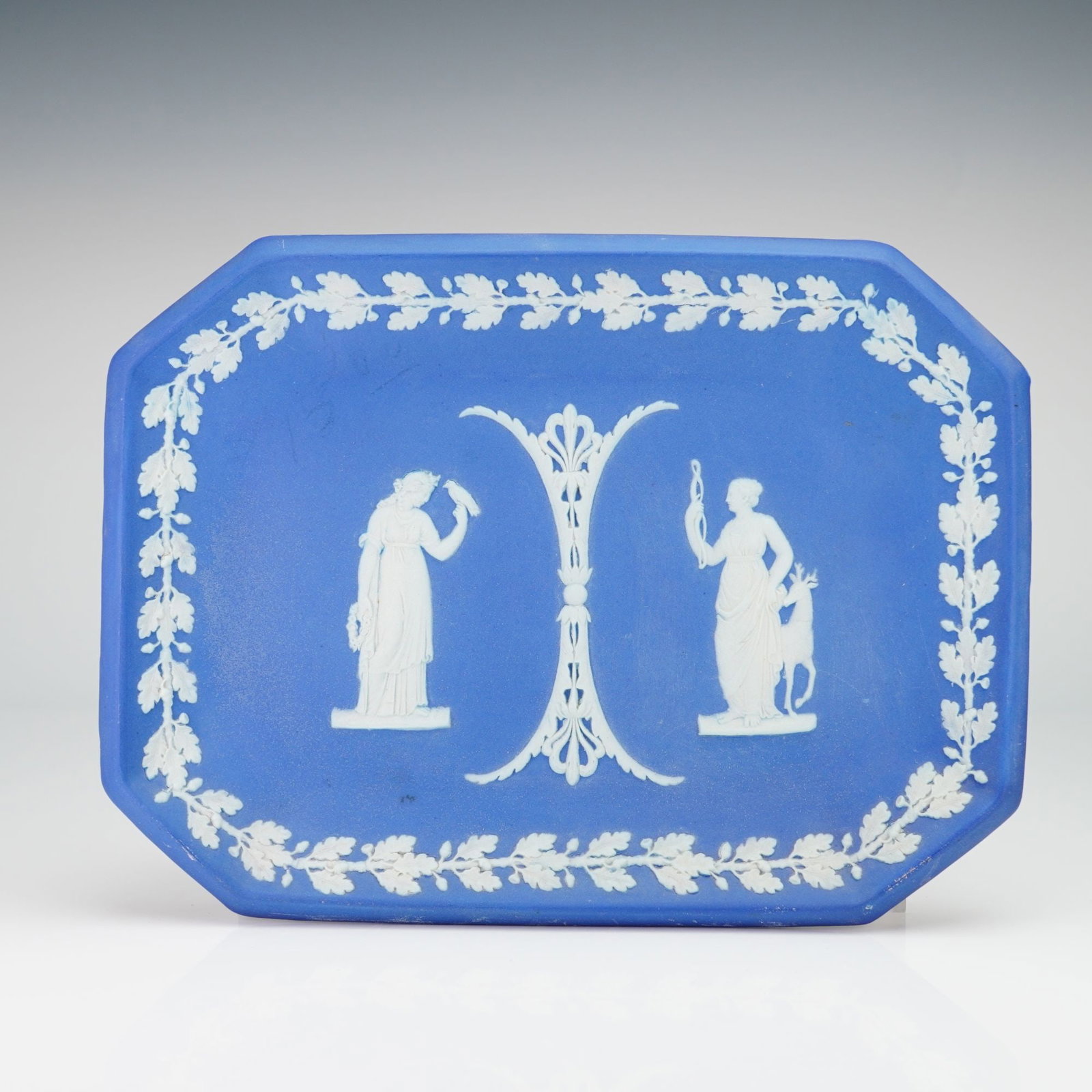 Wedgwood Blue Jasperware Octagonal Tray: This Wedgwood jasperware tray is crafted from unglazed stoneware featuring a matte cobalt blue ground. The octagonal form is decorated with applied white sprigged relief depicting classical motifs. Th