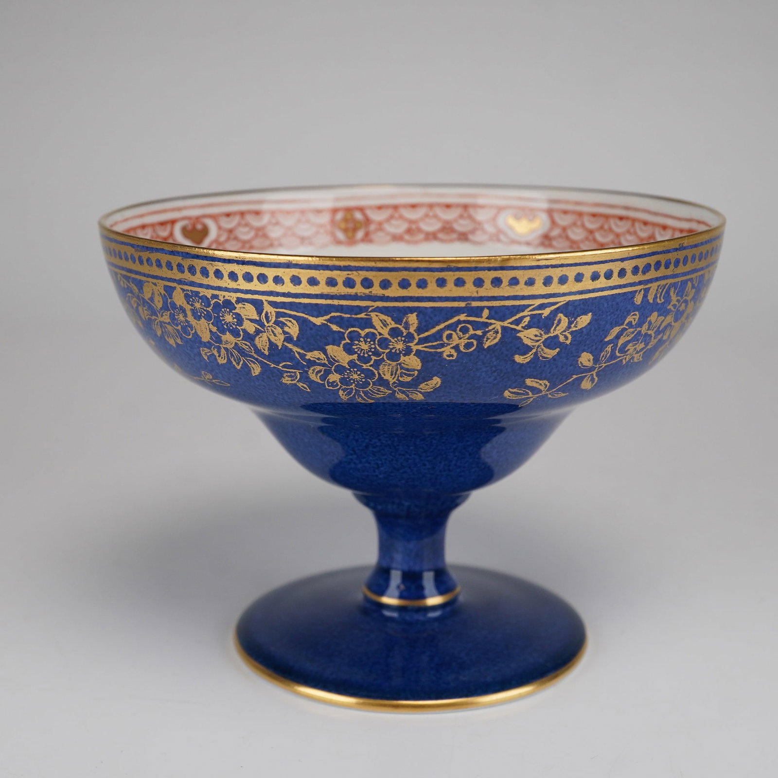 Wedgwood for James Powell and Sons Chinoiserie Blue Footed Bowl: This fine bone china footed bowl was manufactured by Wedgwood in Staffordshire, England, as a special commission for the prestigious London retailer James Powell and Sons (Whitefriars). The exterior o