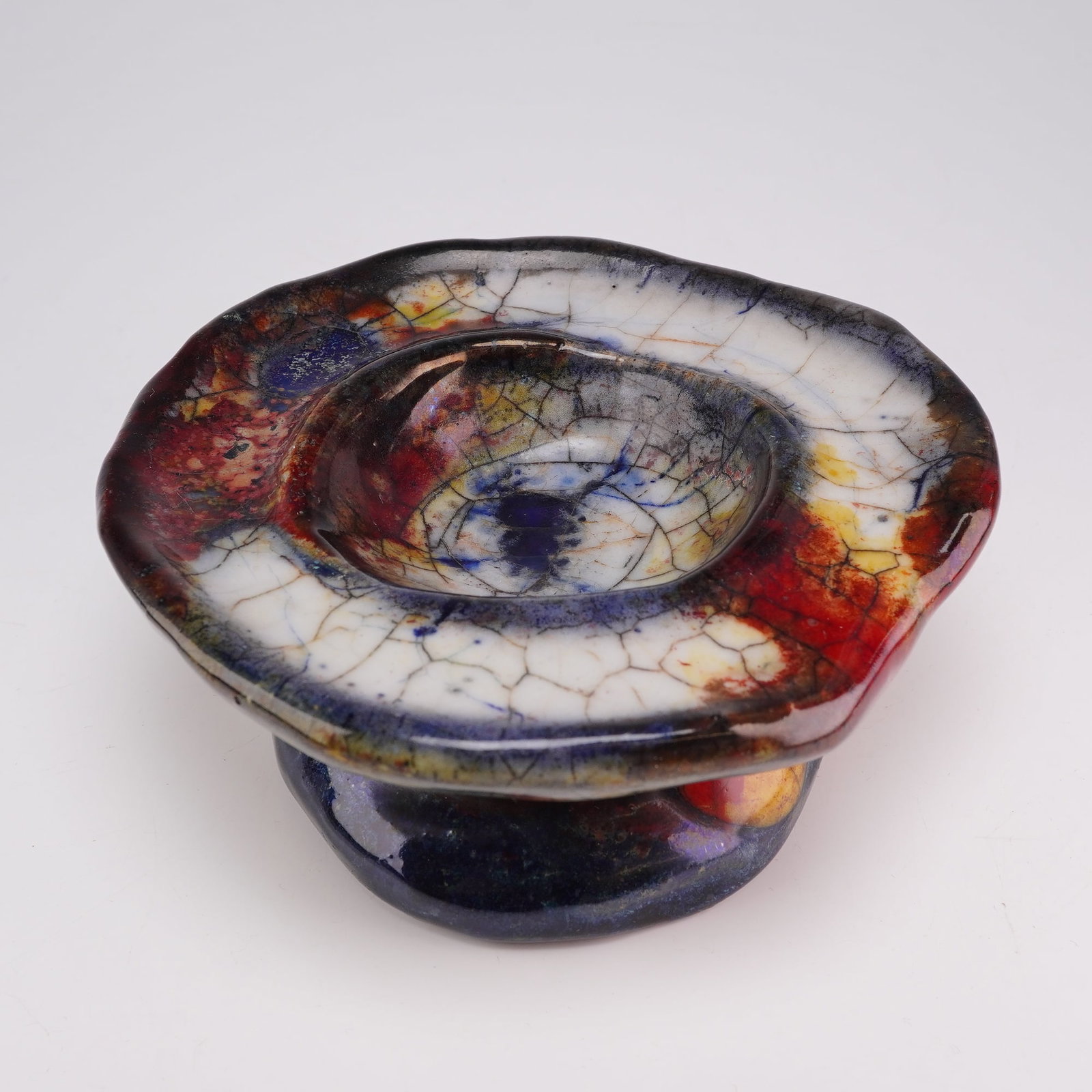 Royal Doulton by Charles Noke and Harry Nixon Flambe Chang Ware Mushroom Bowl: This Royal Doulton Chang mushroom dish is a footed earthenware vessel featuring a thick, multi-layered volcanic glaze. The form consists of an irregular, undulating rim set upon a squat pedestal base.