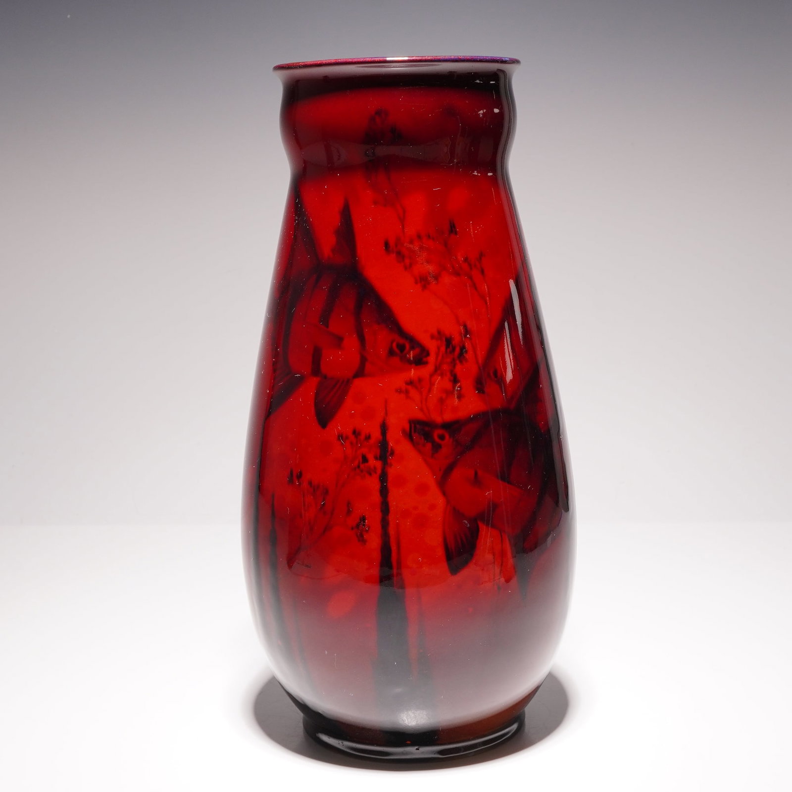 Royal Doulton by Charles Noke Large Flambe Sung Fish Vase, Old Wife: The ovoid body tapers to a constricted neck with a slightly flared rim, resting on a short, unglazed foot rim. The decoration depicts Old Wife fish swimming among stylized seaweed and aquatic flora, r